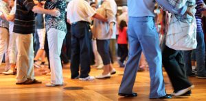 A group of people dancing on a wooden floor at the LIME Foundation in Sonoma County.