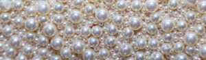 A close up of white pearls on a Santa Rosa Non-Profit background.