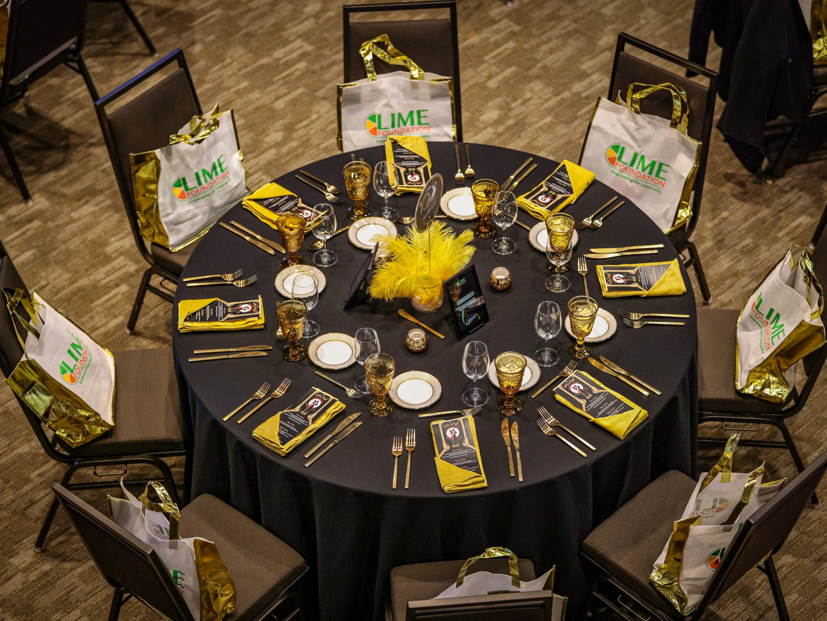 A table setting with yellow plates for a Sonoma County Non-Profit Organization event.