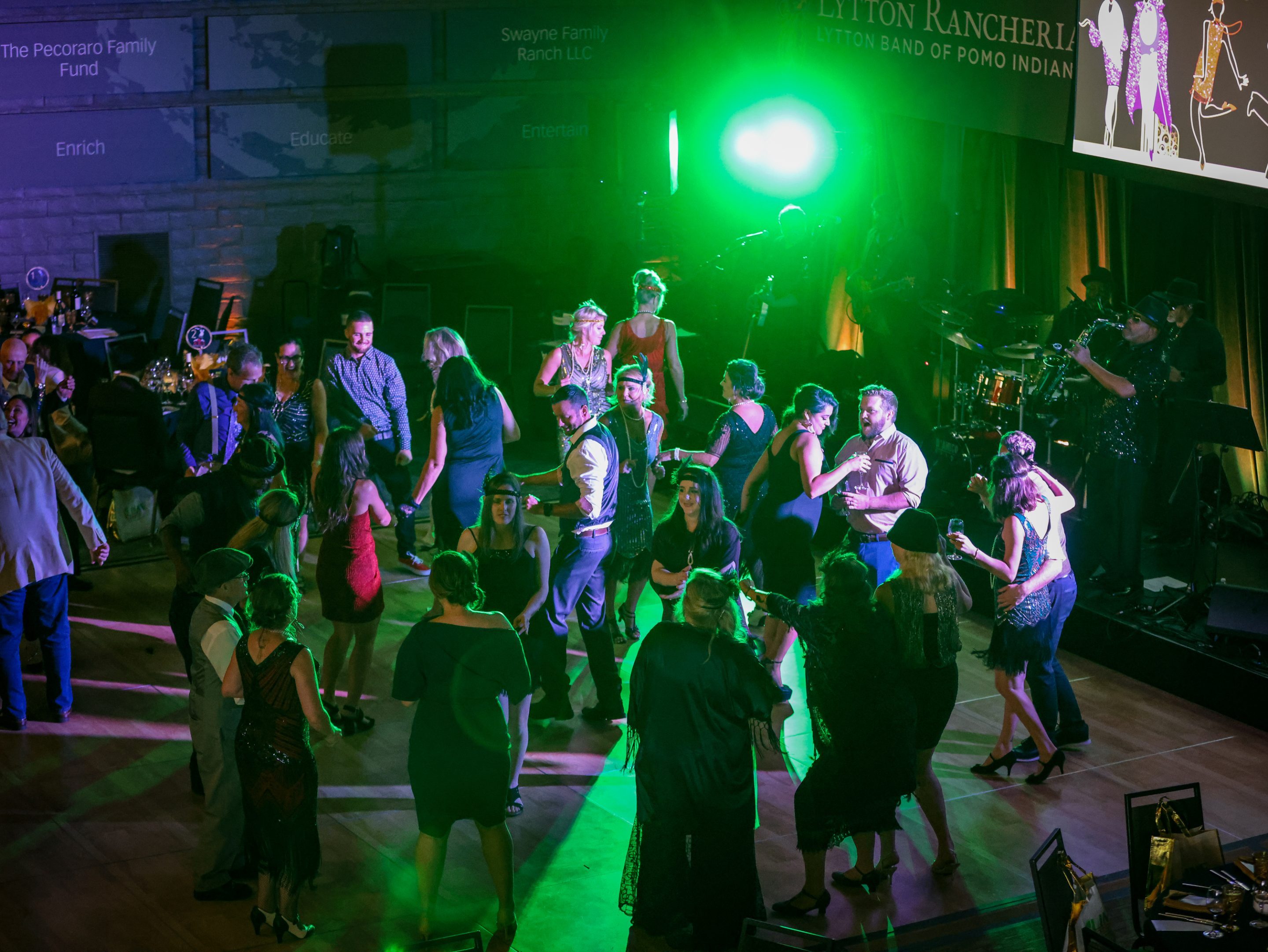 A group of people dancing on a dance floor at a Sonoma County Non-Profit Organization event.