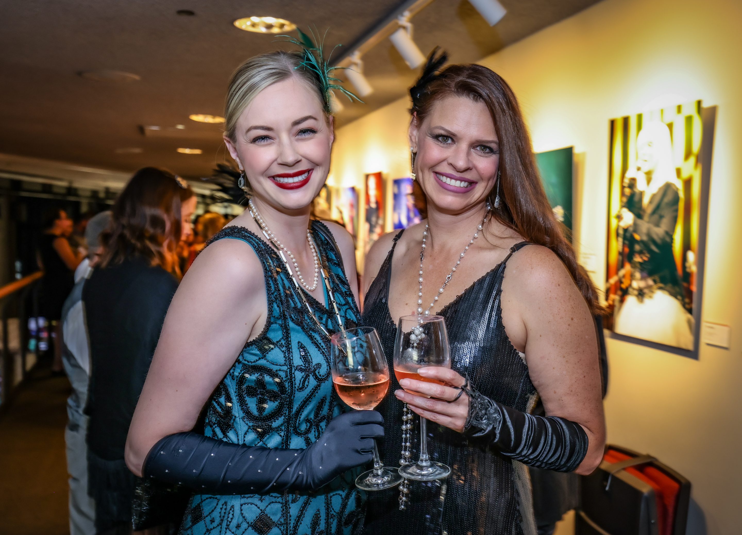 Two women at a LIME Foundation event in Sonoma County holding glasses of wine.