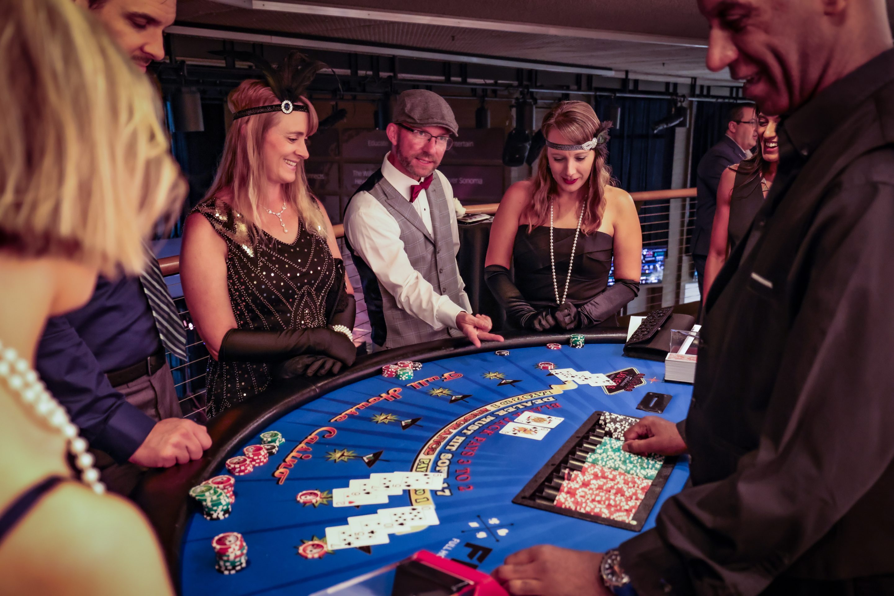 Individuals participating in a casino roulette game.