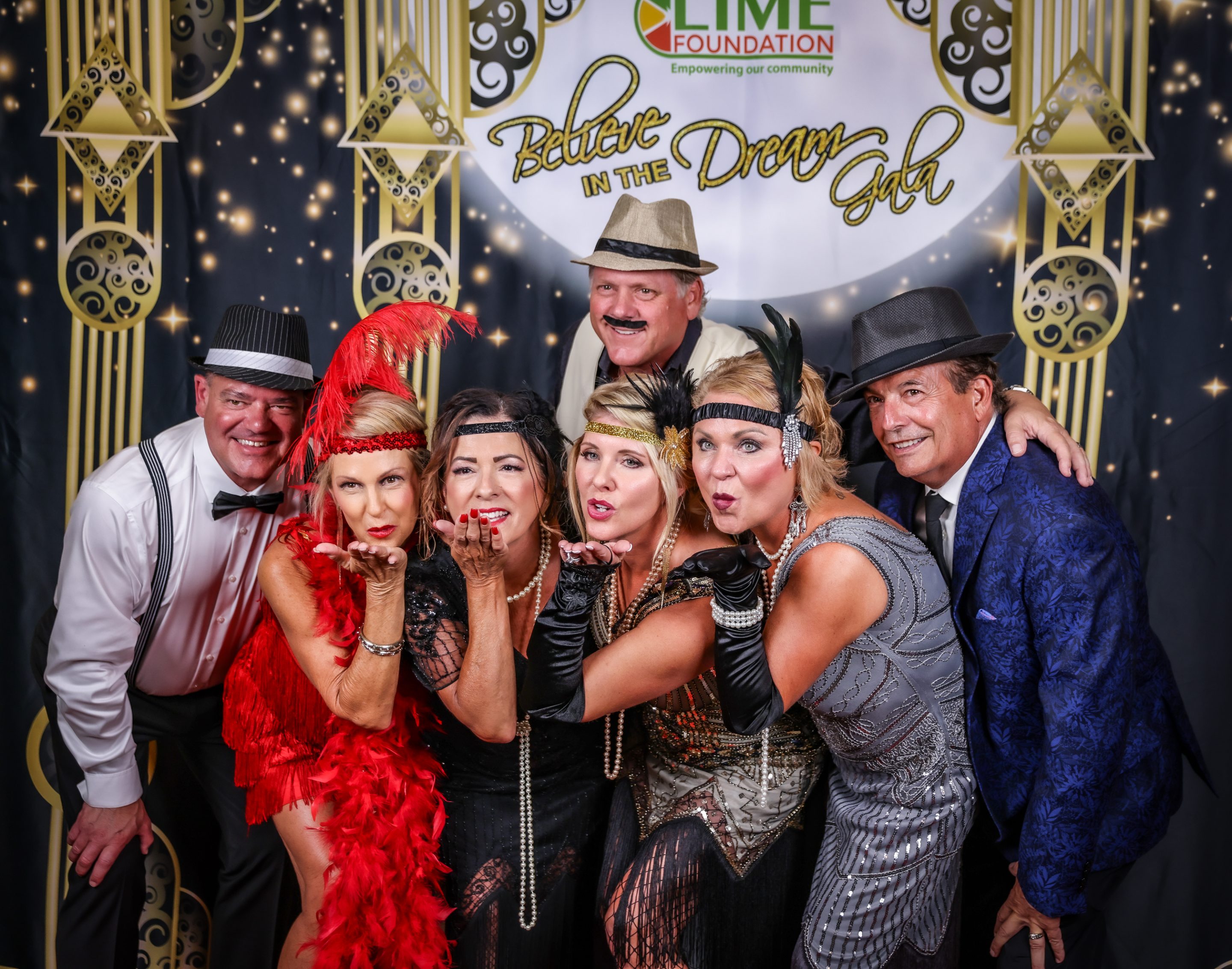 A group of people posing for a photo at a Gatsby-themed party hosted by The LIME Foundation of Santa Rosa.