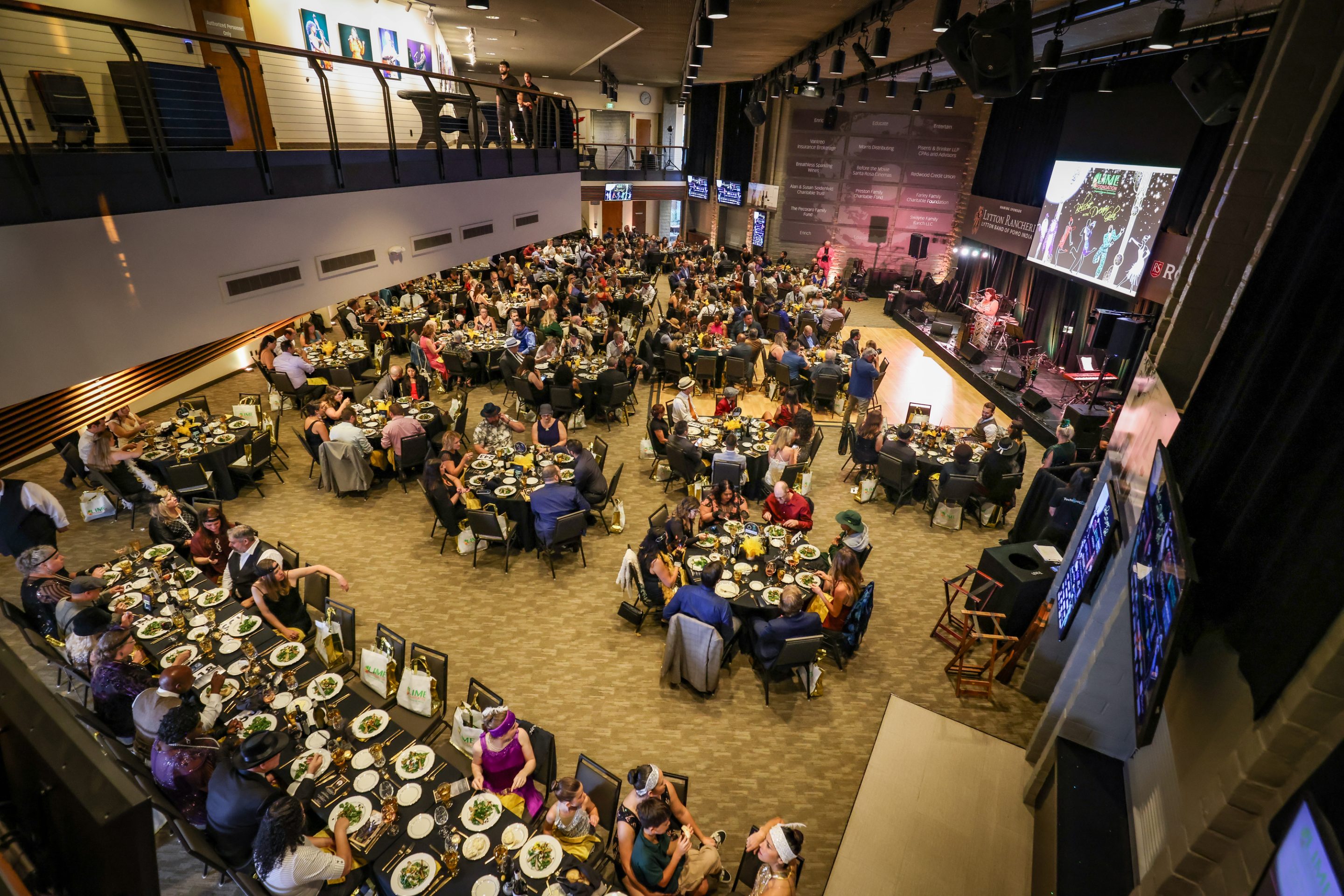 This is an aerial view of a large room at the LIME Foundation event, with people seated at tables.
