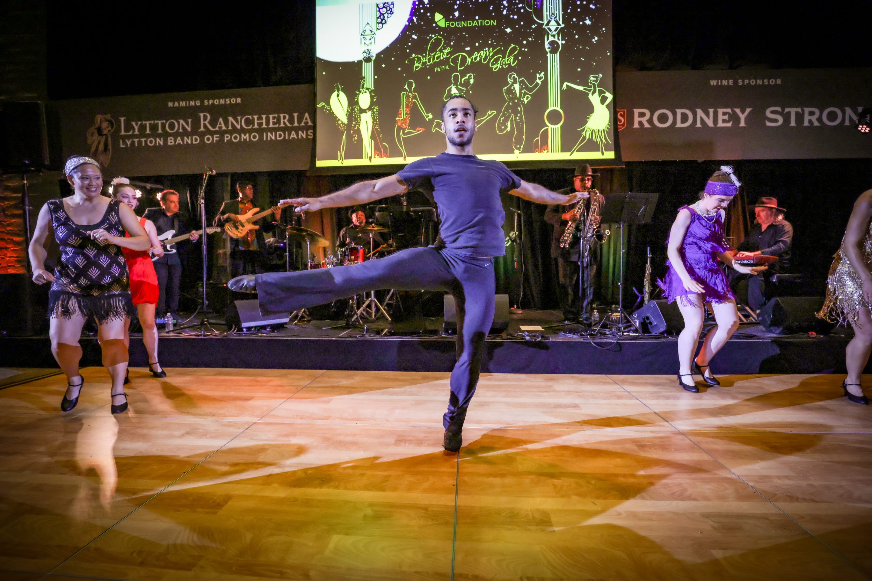 A group of people dancing on a stage at The LIME Foundation of Santa Rosa, a Sonoma County non-profit organization.