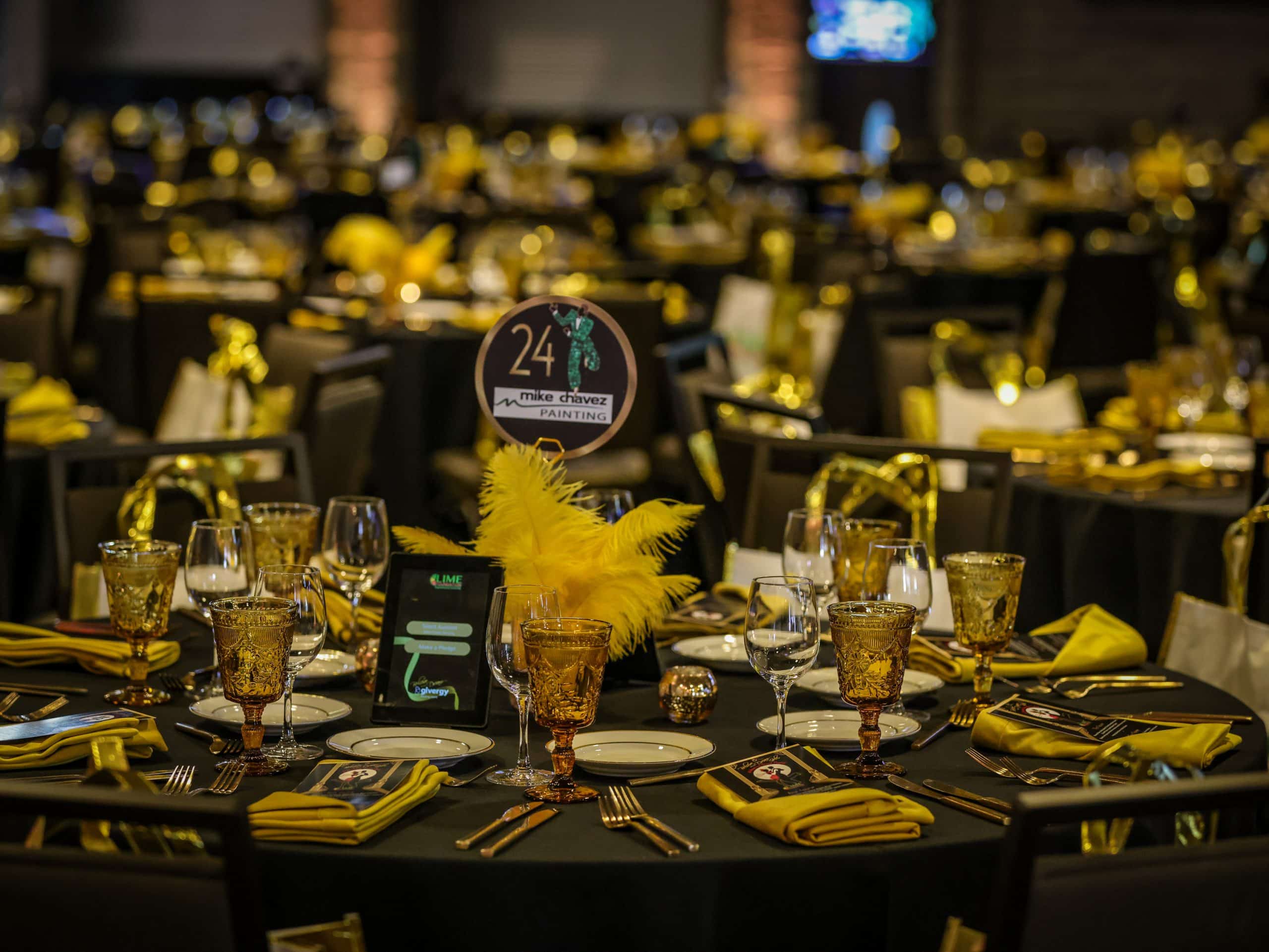 A banquet table set with yellow and black tablecloths at The LIME Foundation of Santa Rosa.