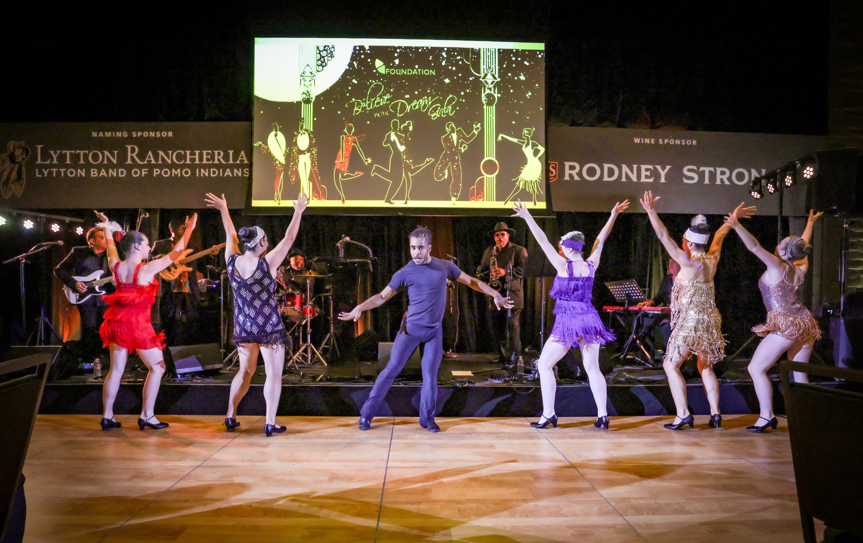 A group of dancers performing on stage at a Sonoma County Non-Profit event.