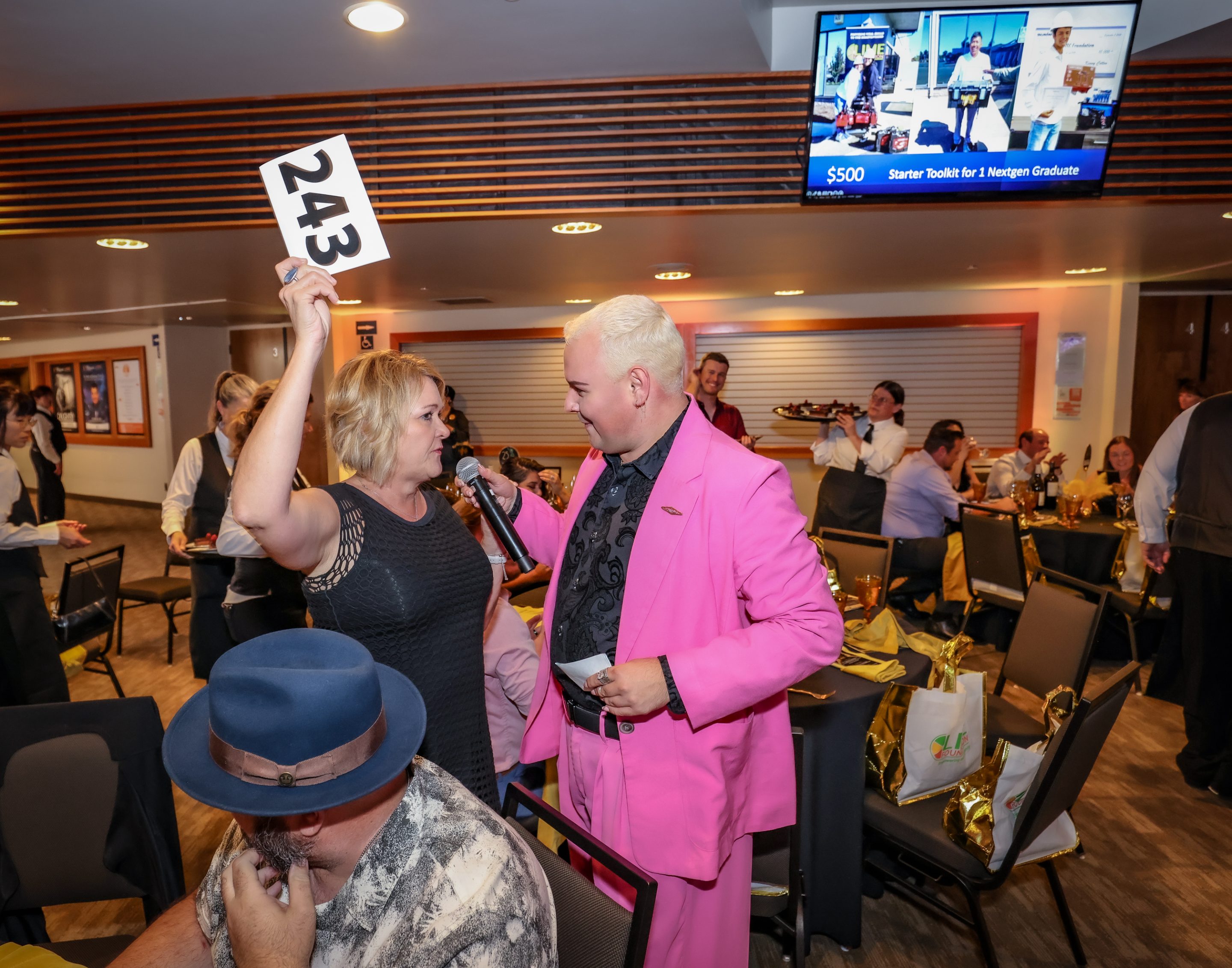 A man in a pink suit is holding up a sign for The LIME Foundation of Santa Rosa, a Sonoma County Non-Profit Organization.