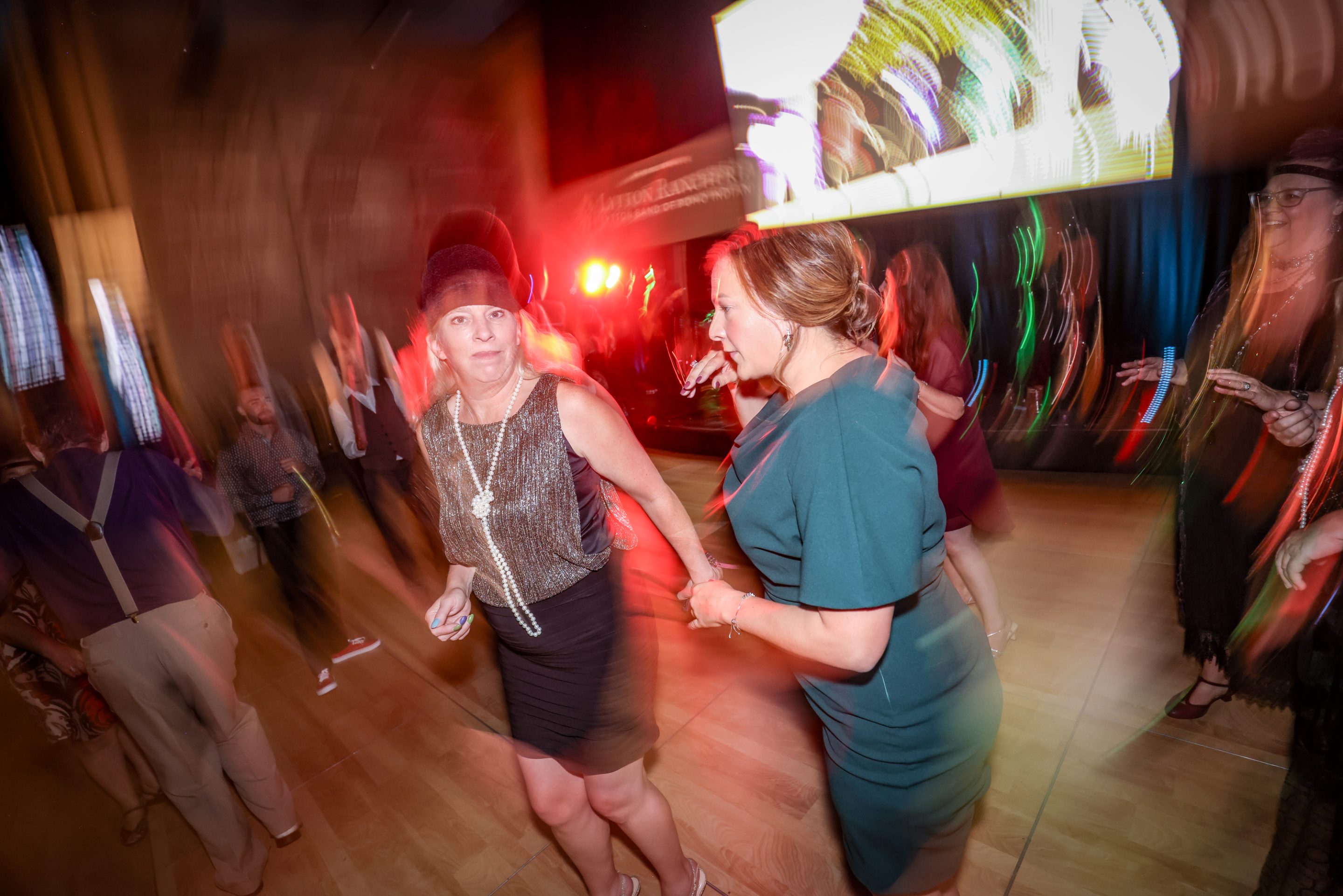 Two women dancing on a dance floor at a Santa Rosa Non-Profit event hosted by The LIME Foundation.