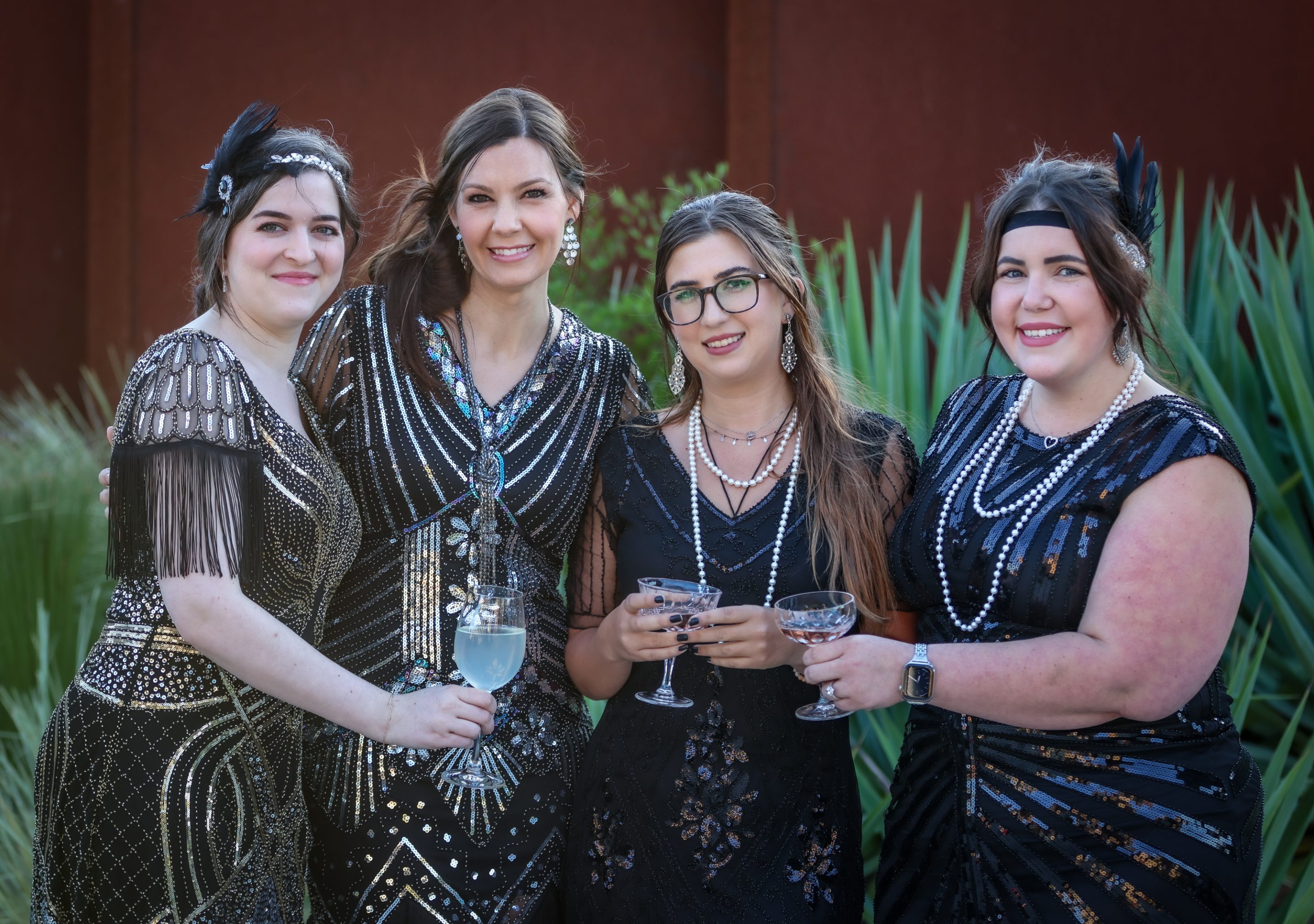 A group of women in black dresses posing for a photo at a LIME Foundation event.
