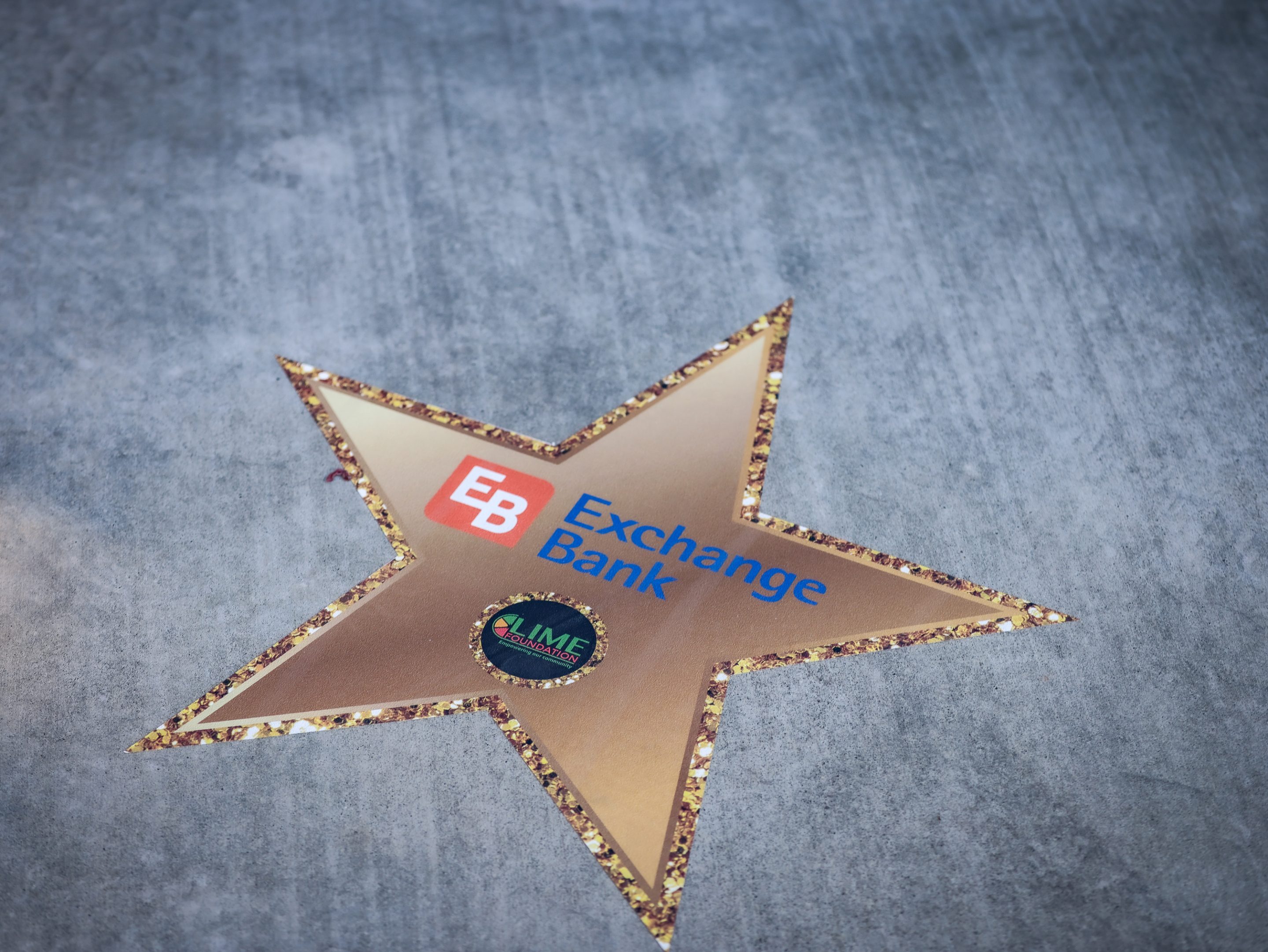 A gold star with the word "Exchange Bank" on it is a symbol of recognition.
