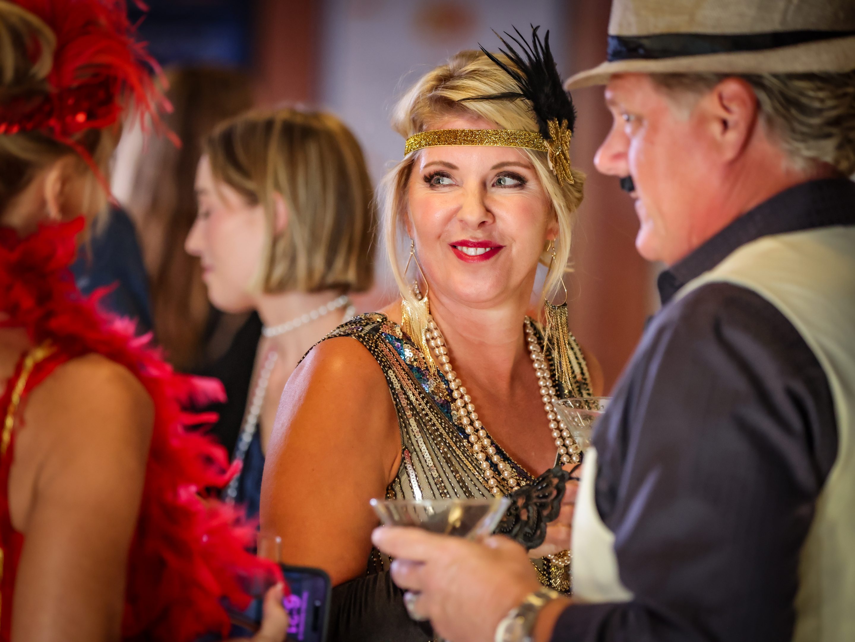A group of people at a party dressed in flapper costumes hosted by The LIME Foundation of Santa Rosa.