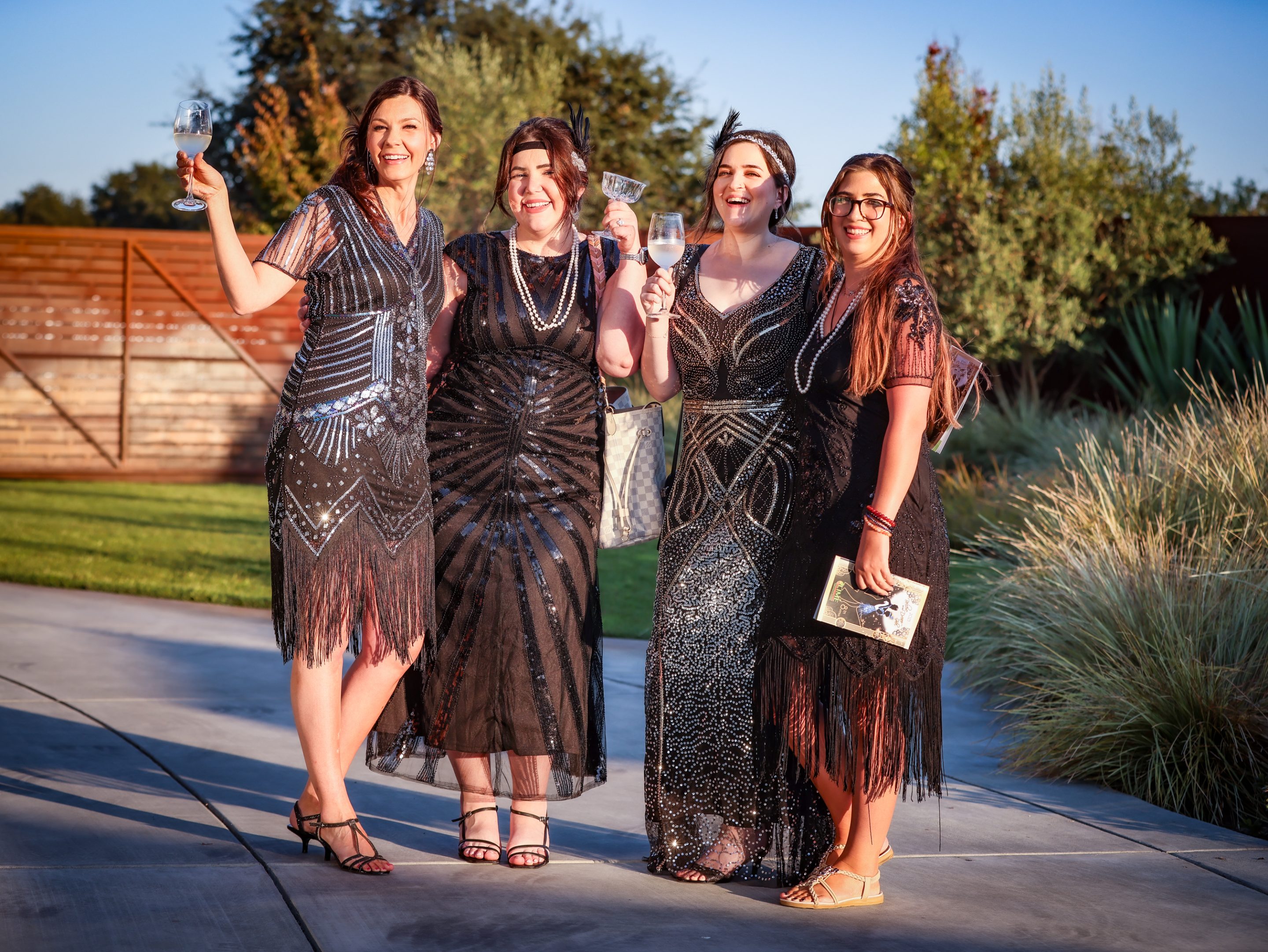 Four women in black dresses posing for a photo at The LIME Foundation of Santa Rosa.