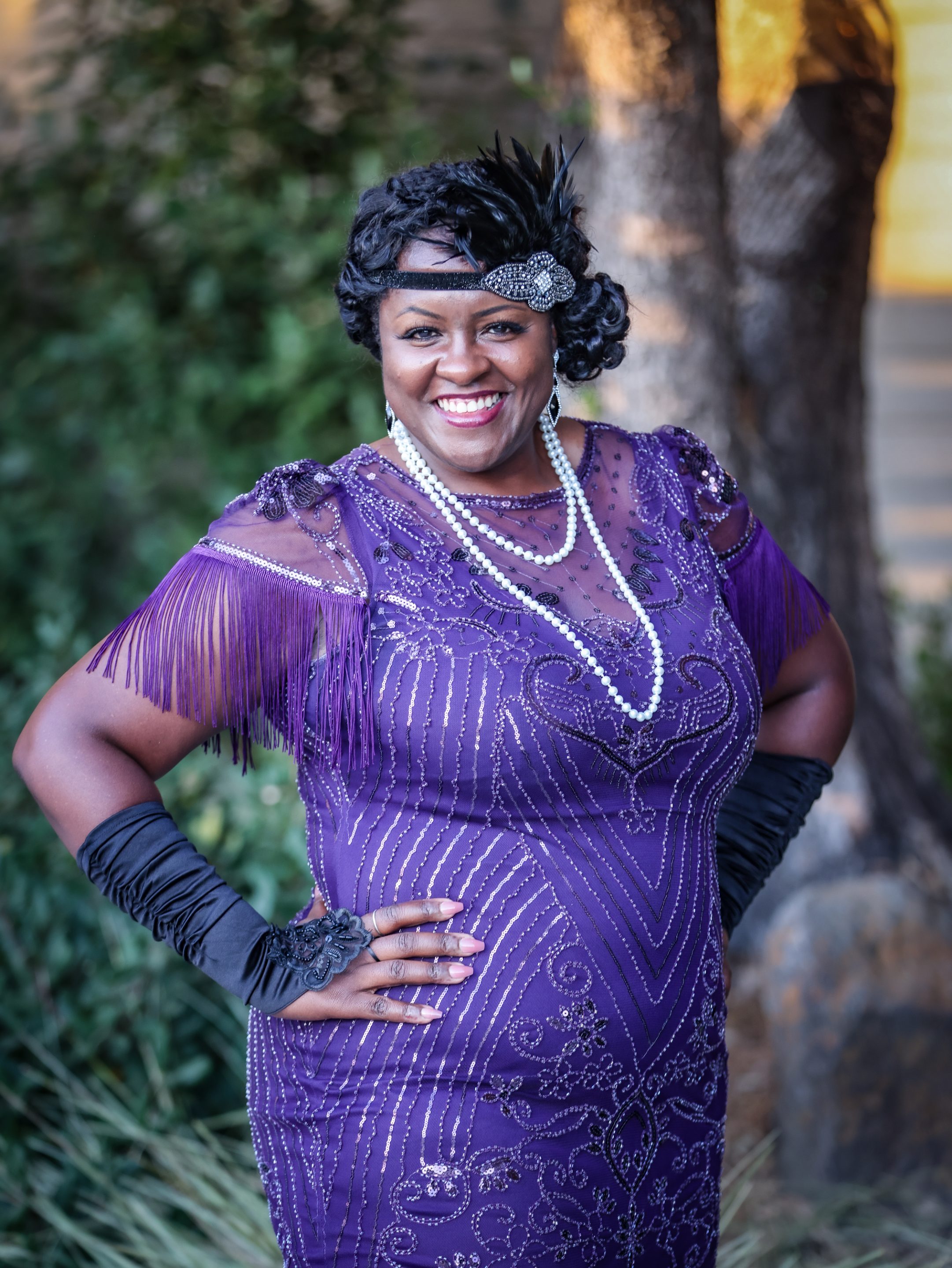 A woman in a purple dress posing for a photo at a Sonoma County non-profit organization event.