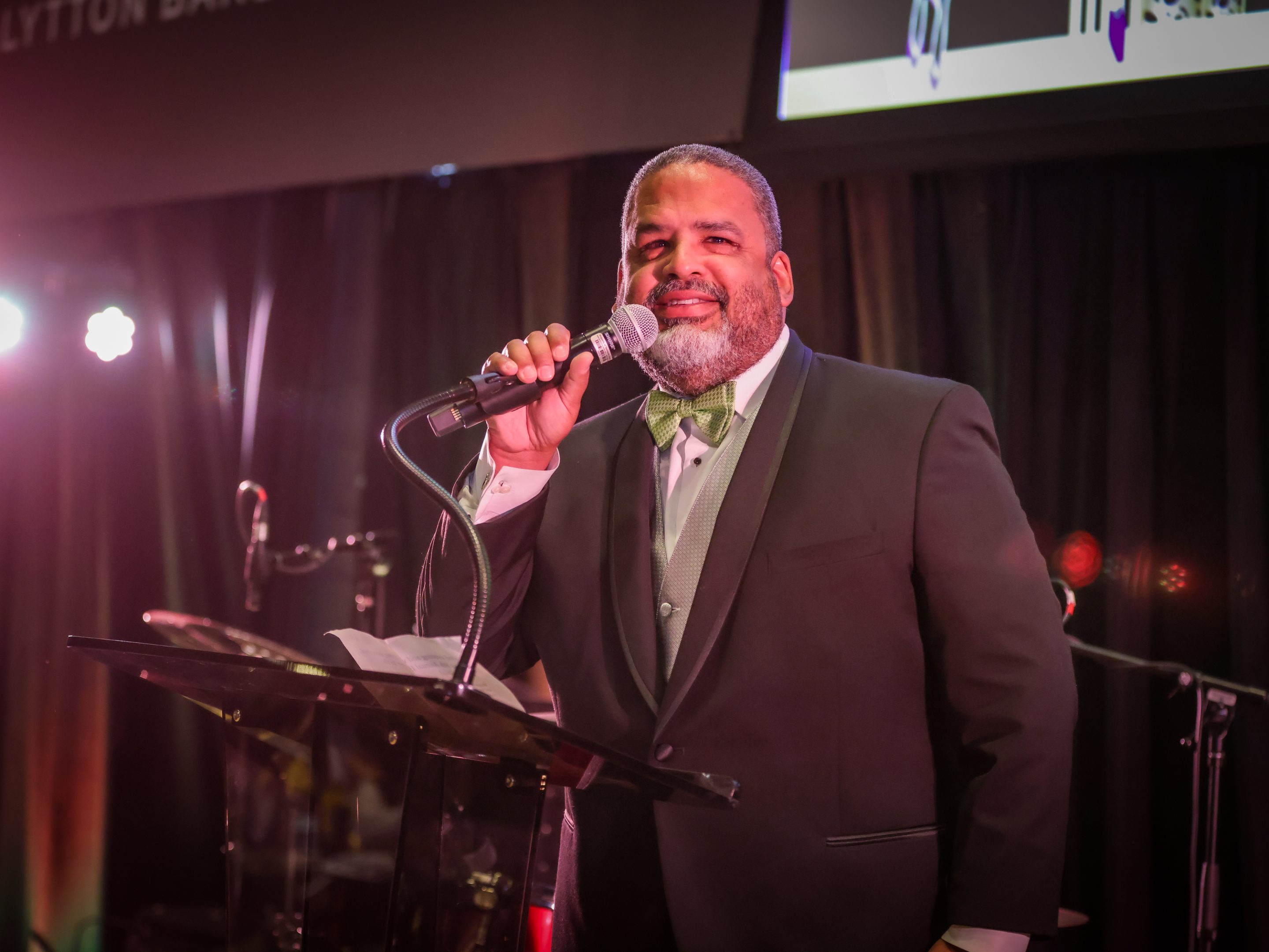 A man in a tuxedo singing into a microphone at The LIME Foundation fundraiser event in Santa Rosa.