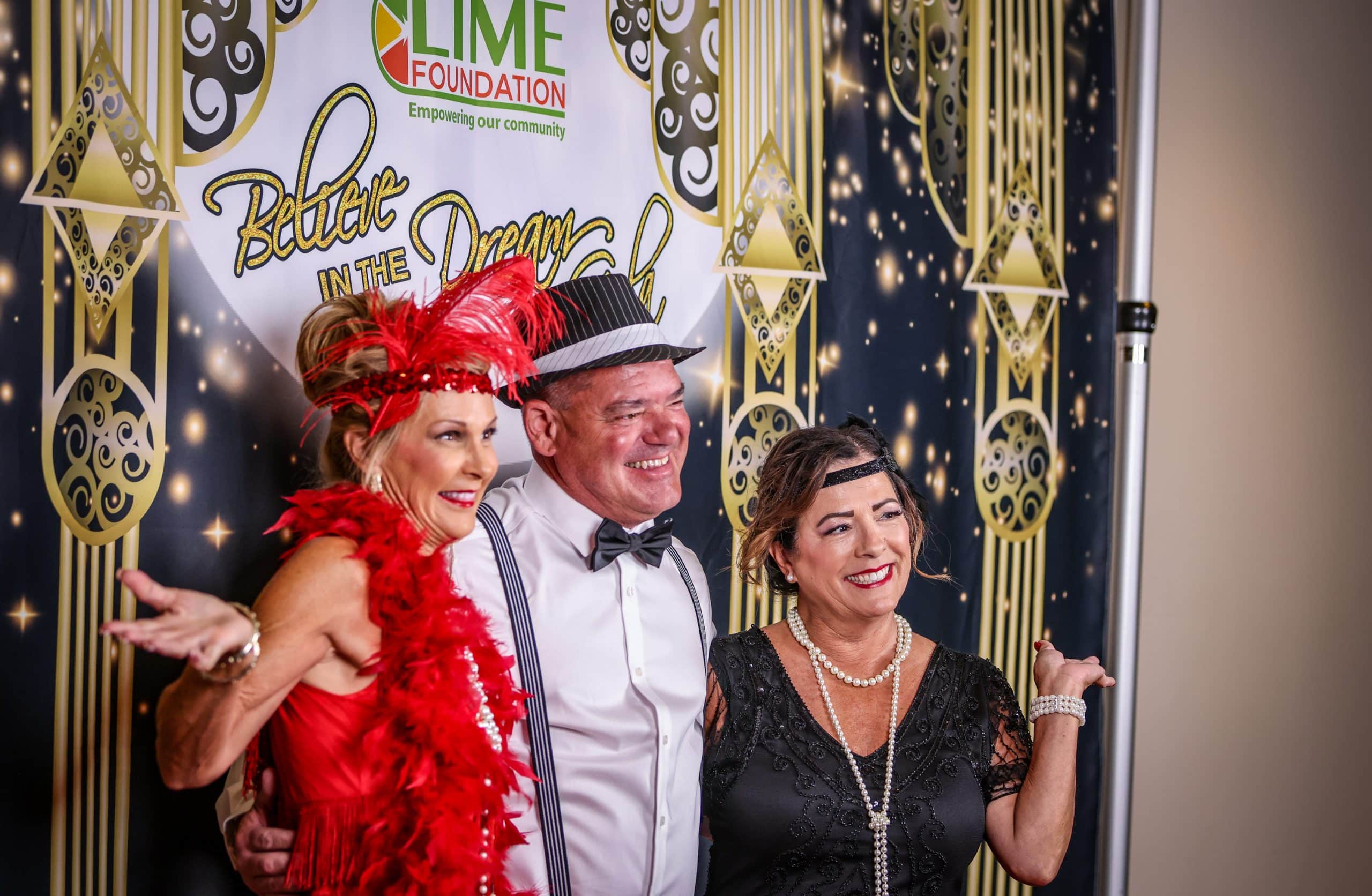 A group of people posing for a photo at a 1920's themed party hosted by The LIME Foundation of Santa Rosa.