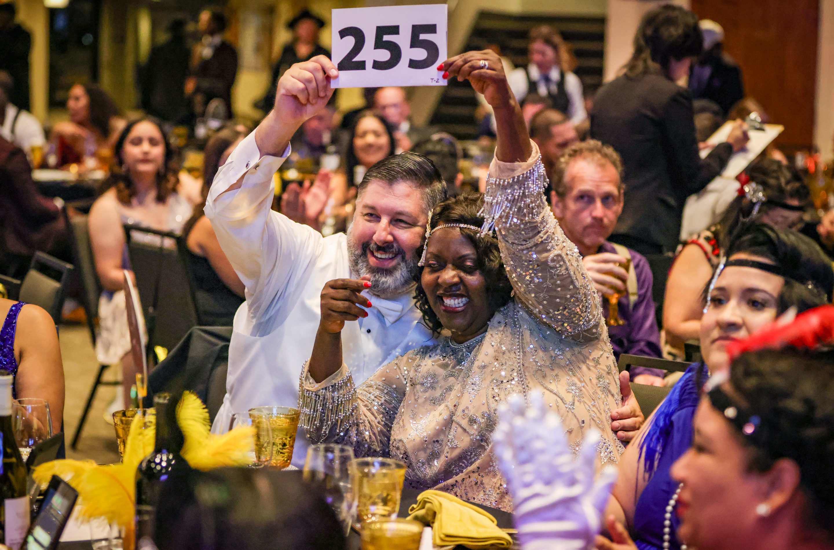 A group of people holding up a number at a dinner hosted by The LIME Foundation of Santa Rosa, a Sonoma County Non-Profit Organization.