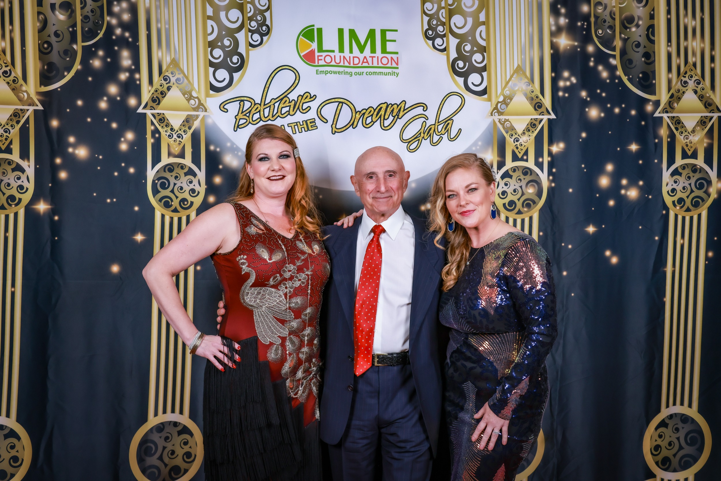 Three individuals posing for a photo at a party hosted by The LIME Foundation of Santa Rosa.