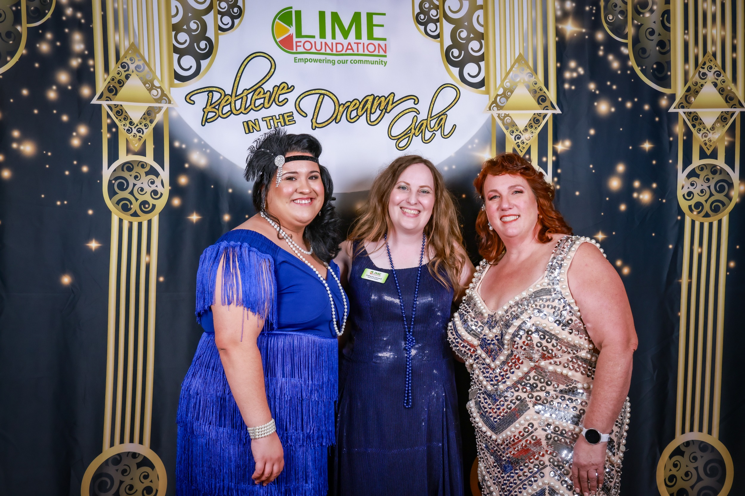 Three women posing for a photo at a 1920's themed event hosted by a Sonoma County Non-Profit.