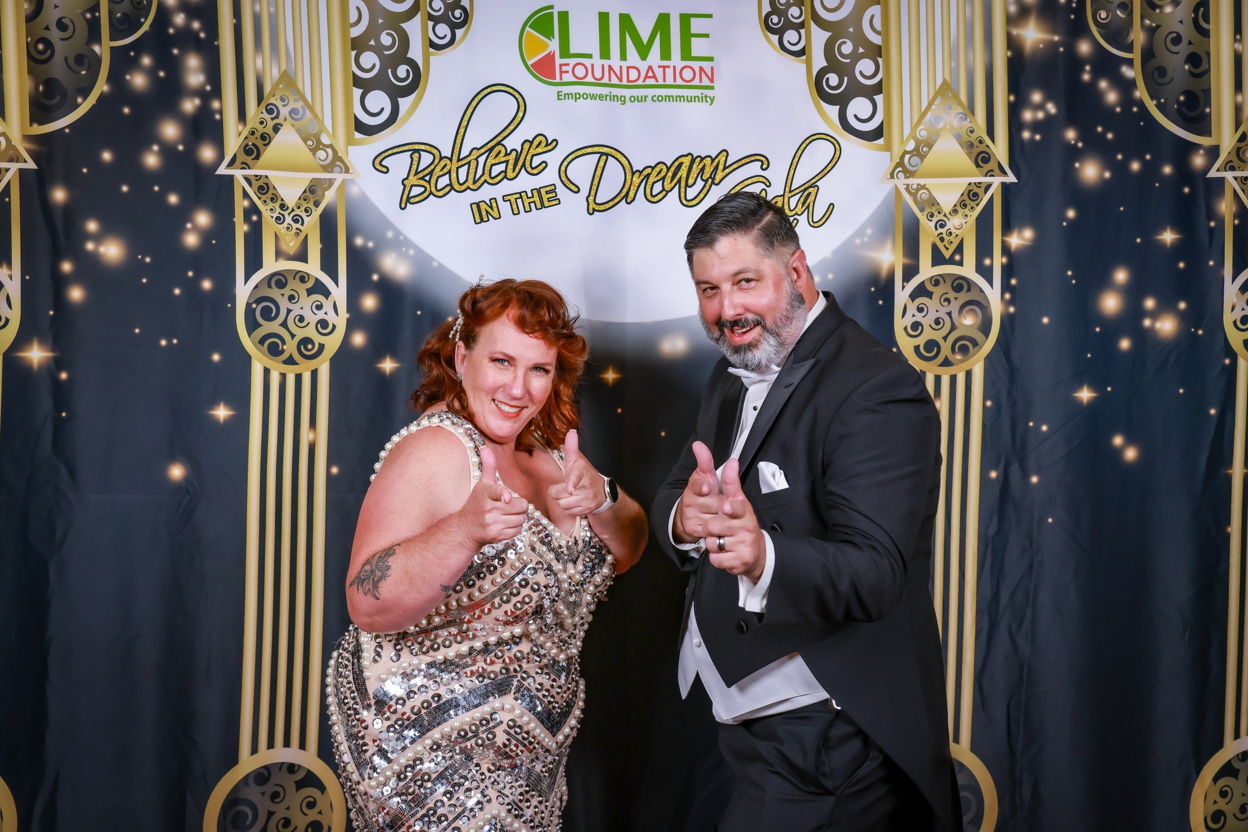 A couple posing for a photo at a Sonoma County party hosted by The LIME Foundation.