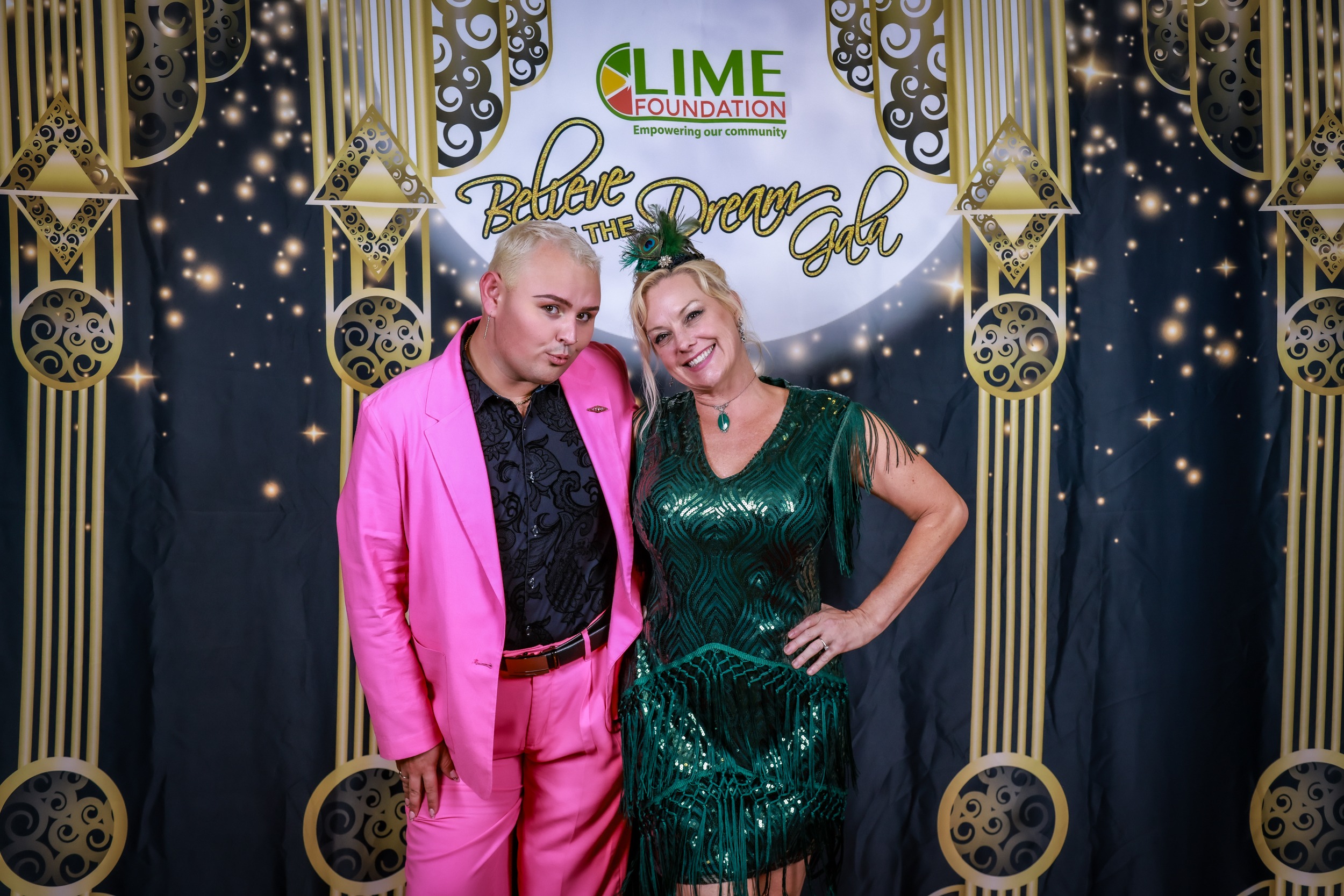 A man and woman posing for a photo in pink outfits. The LIME Foundation of Santa Rosa may have sponsored the event.