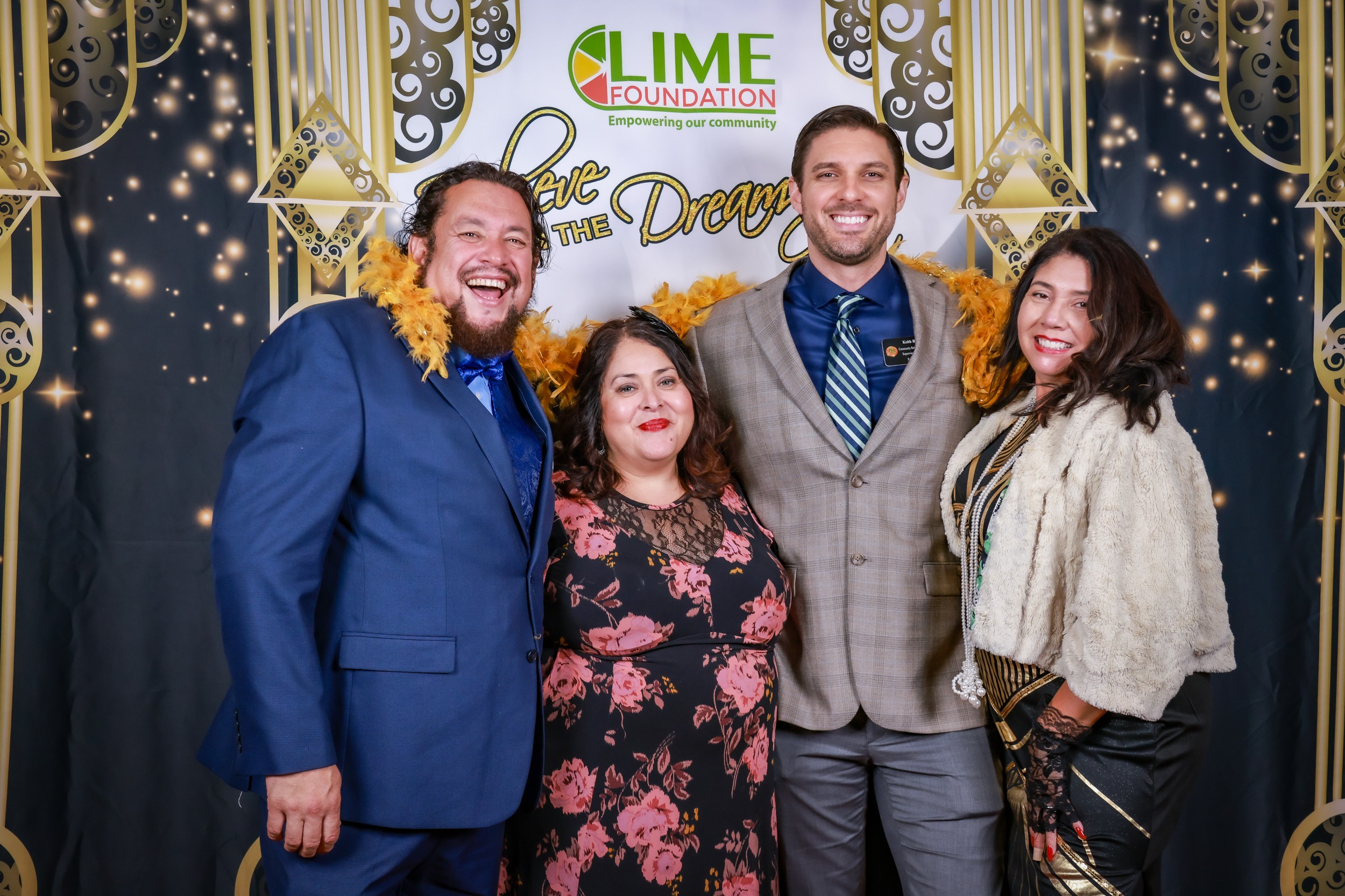 A group of people posing for a photo at a party hosted by The LIME Foundation of Santa Rosa.
