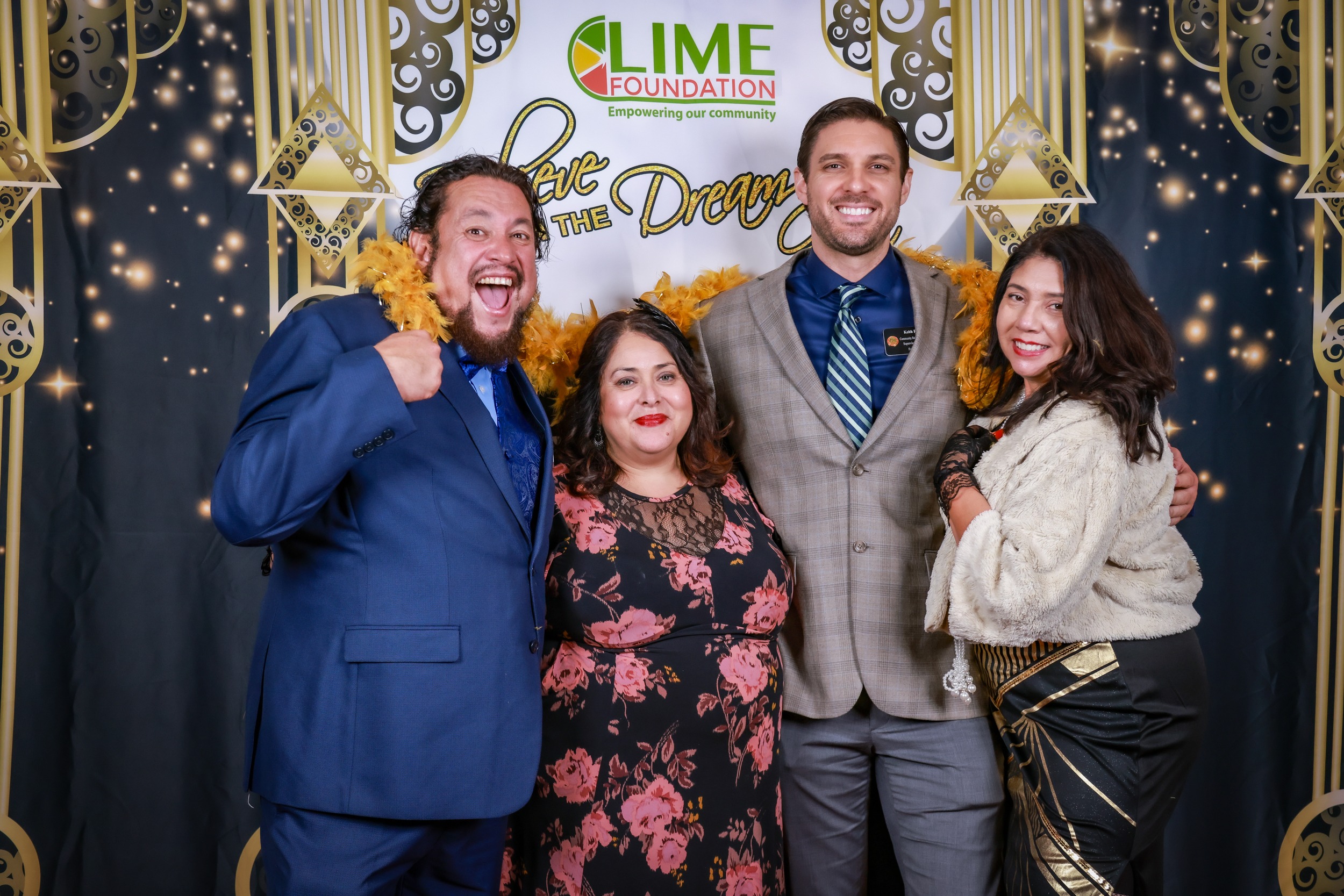 A group of people posing for a photo at a photo booth during an event hosted by The LIME Foundation of Santa Rosa.