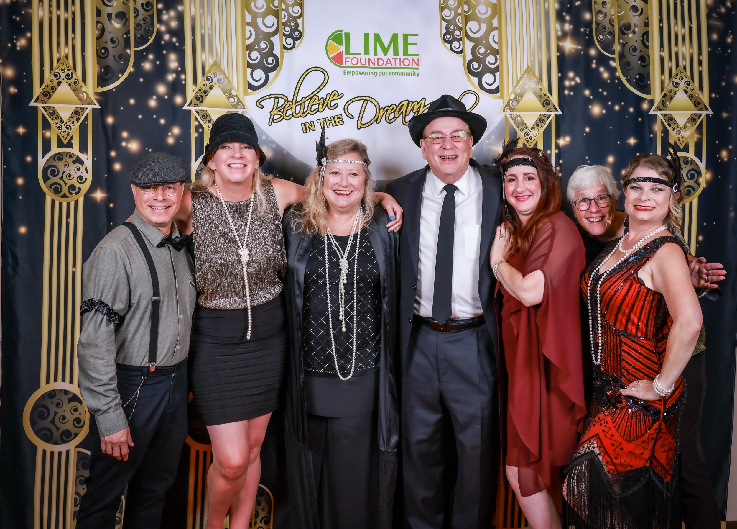 A group of people posing for a photo at a Gatsby themed party hosted by the Sonoma County Non-Profit Organization.
