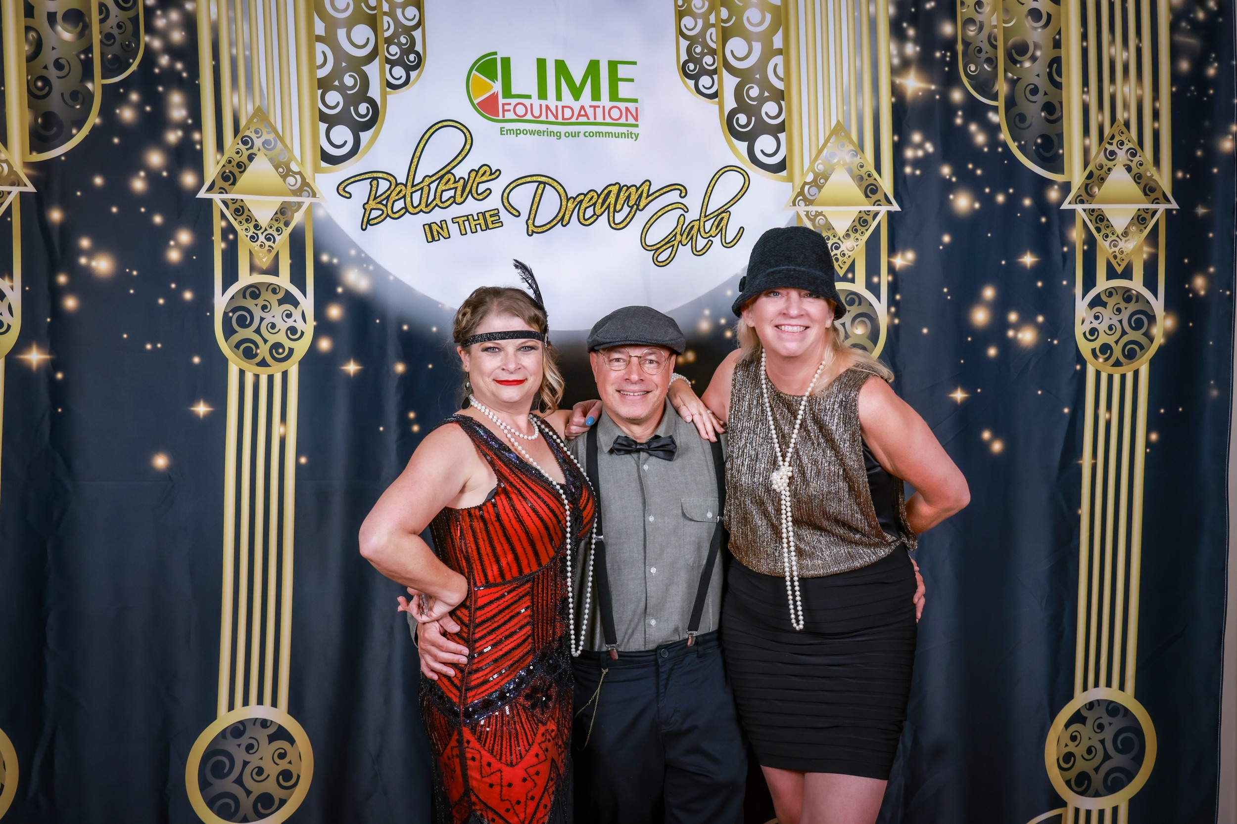 Three people posing for a photo at a 1920's themed party hosted by The LIME Foundation of Santa Rosa.