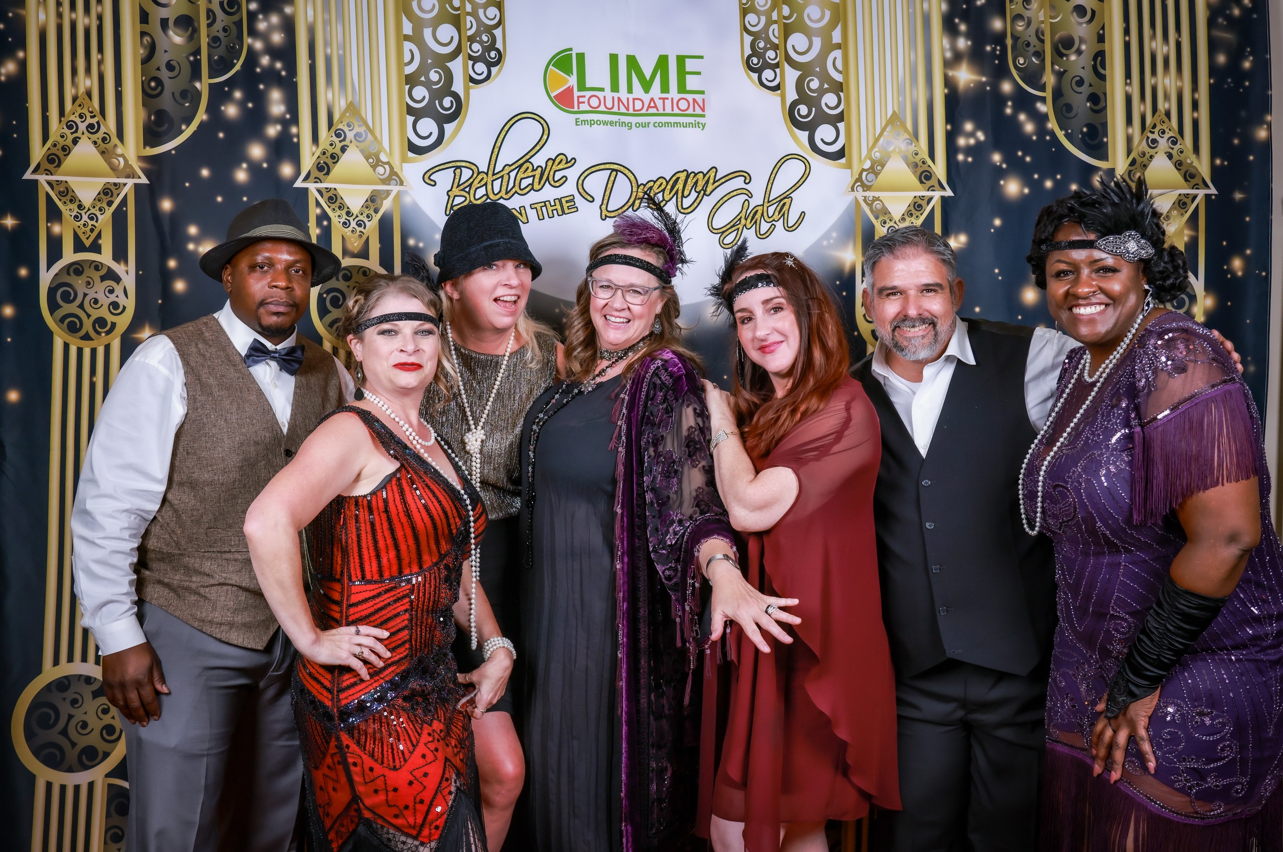 A group of people posing for a photo at a 1920s themed party hosted by The LIME Foundation of Santa Rosa.