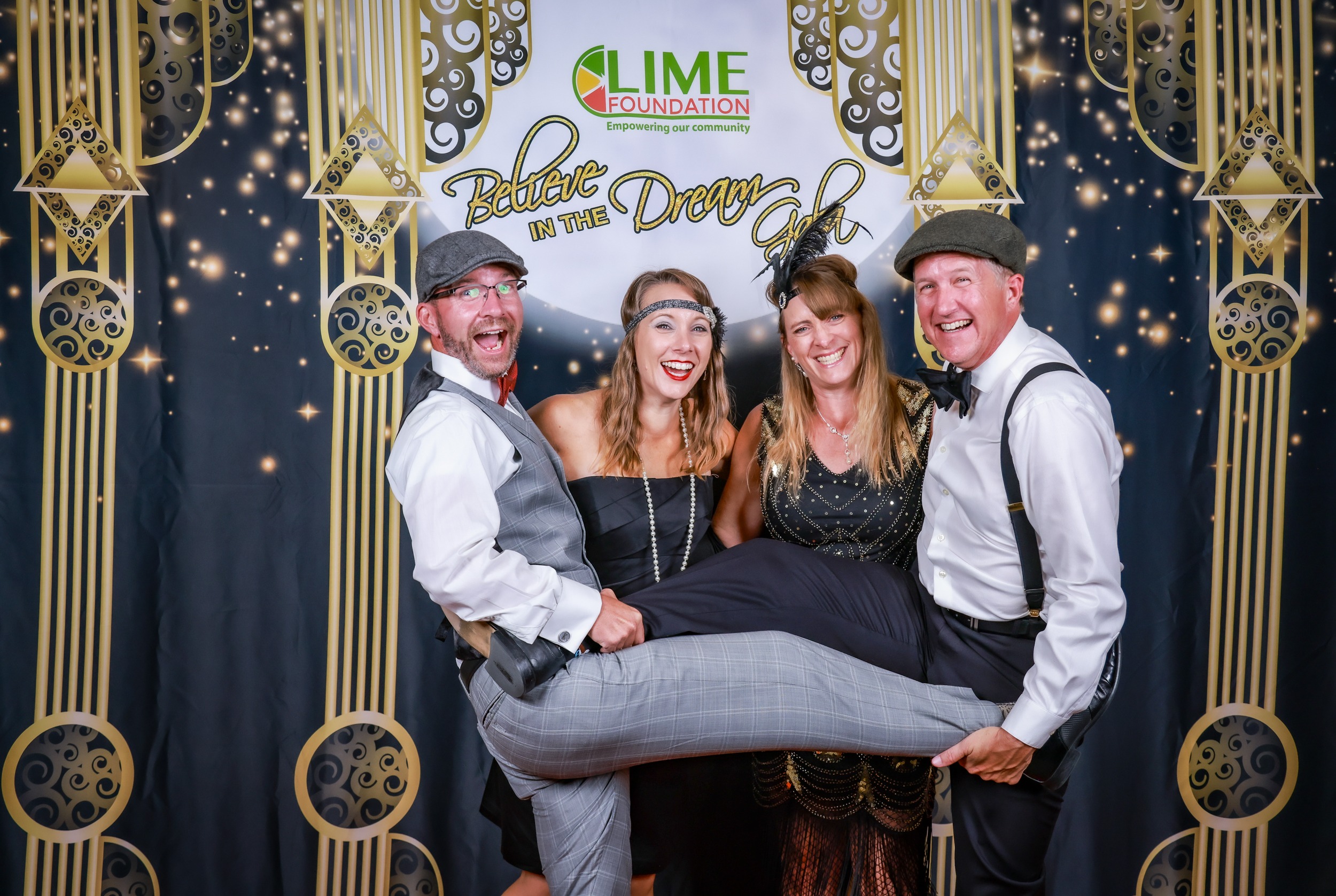 A group of people posing for a photo at a 1920's themed party hosted by The LIME Foundation of Santa Rosa.