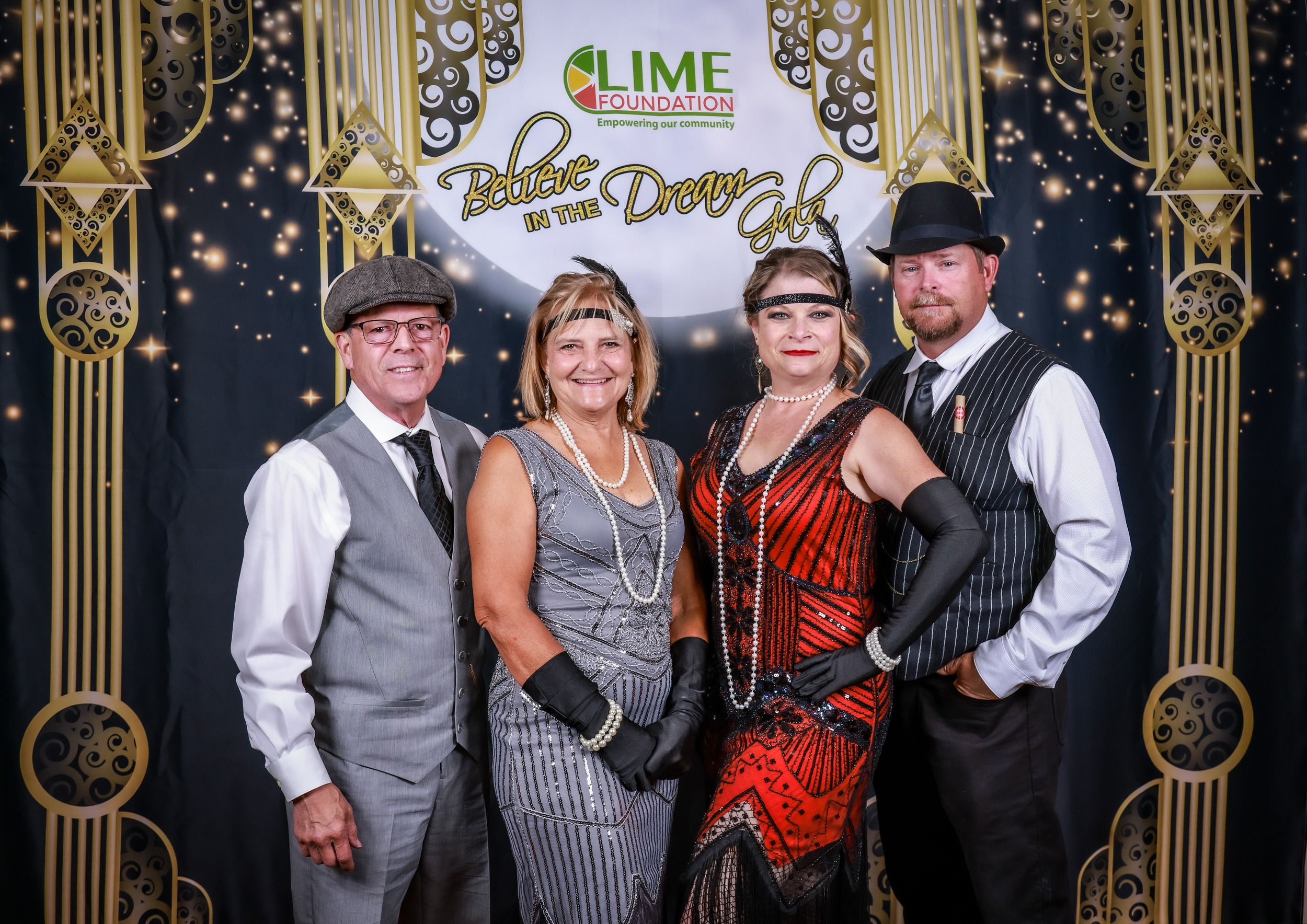 A group of people posing for a photo at a 1920's themed party hosted by the Sonoma County Non-Profit Organization.