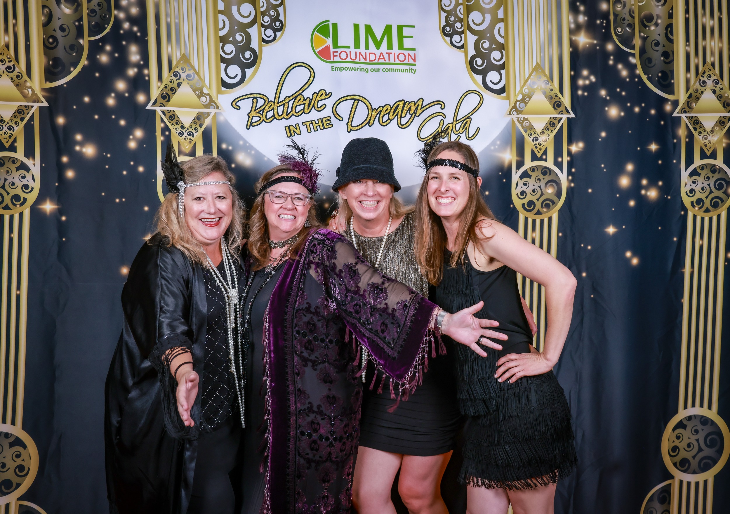 A group of women from the LIME Foundation posing for a photo at a 1920's themed party in Sonoma County.