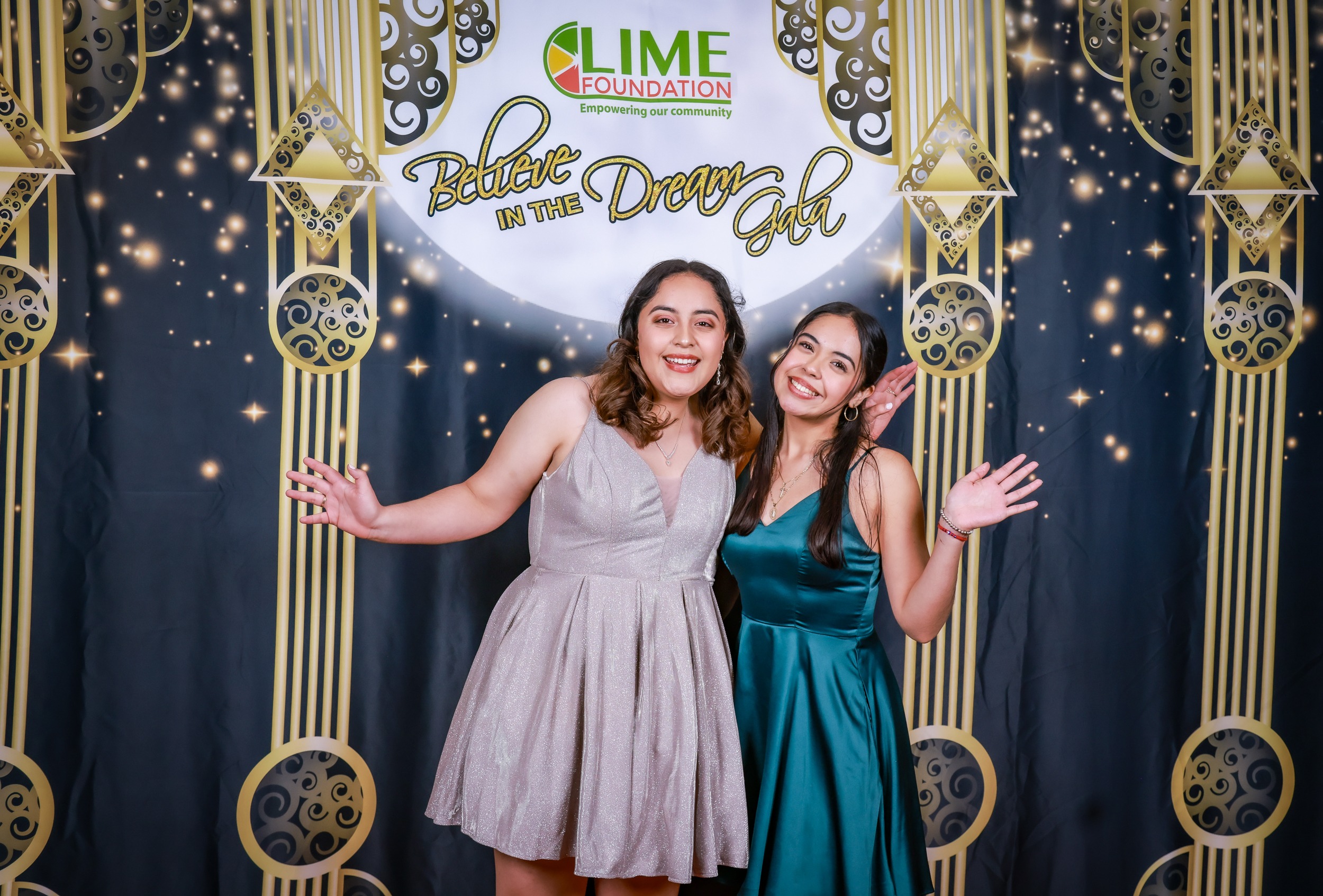 Two women posing for a photo in front of a gold backdrop at The LIME Foundation of Santa Rosa.