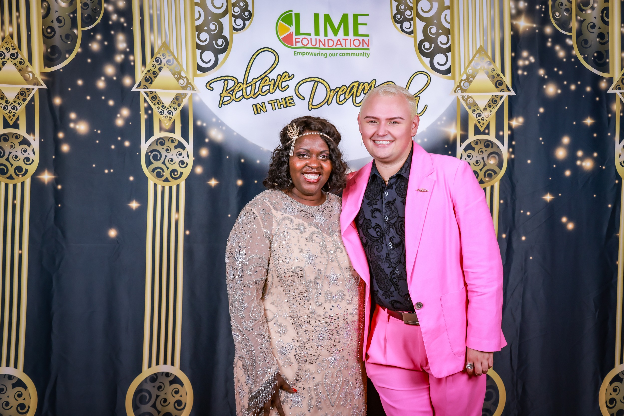 A man in a pink suit and a woman in a pink dress at an event held by Sonoma County Non-Profit Organization.