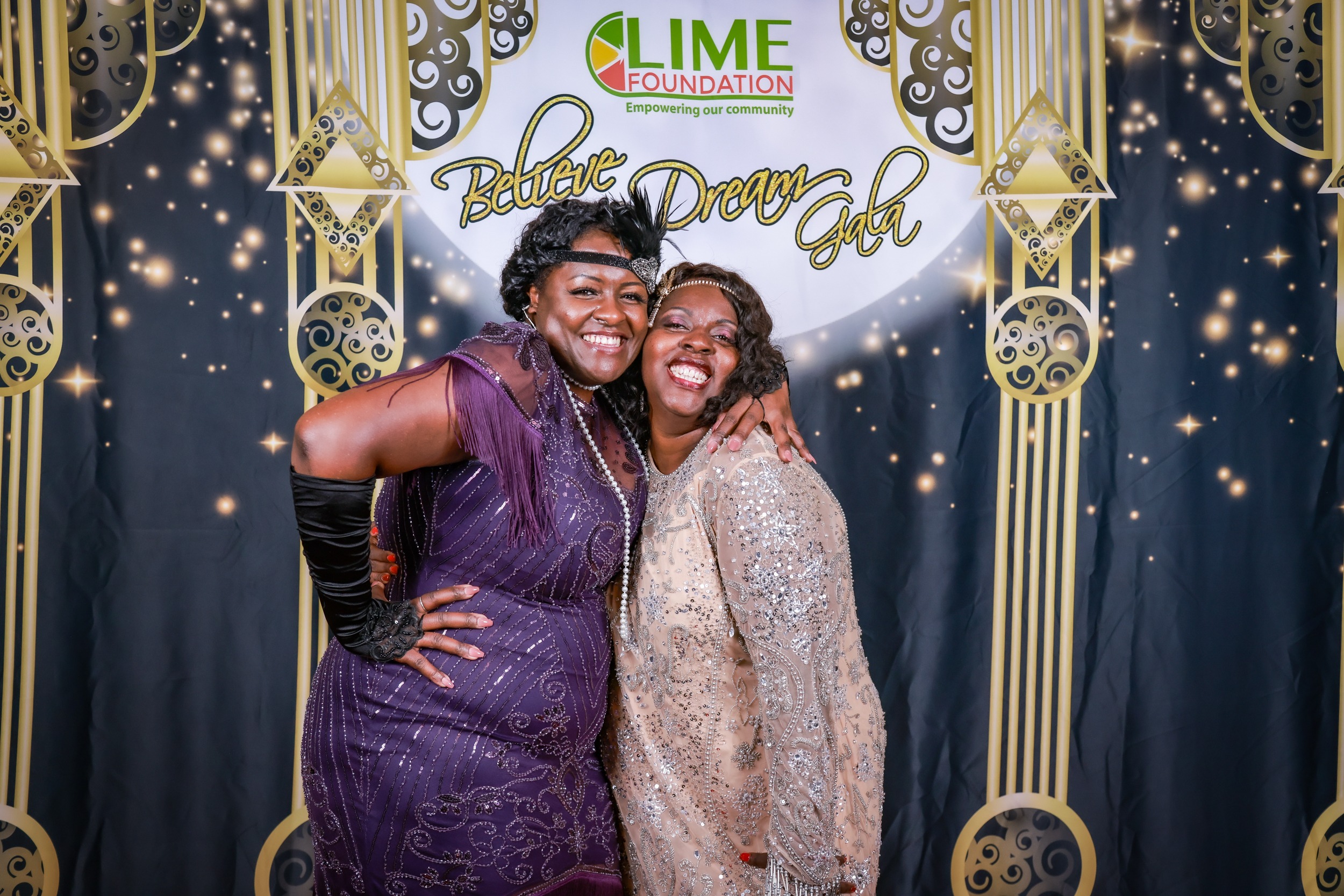 Two women posing for a photo at a 1920's themed party hosted by The LIME Foundation of Santa Rosa.