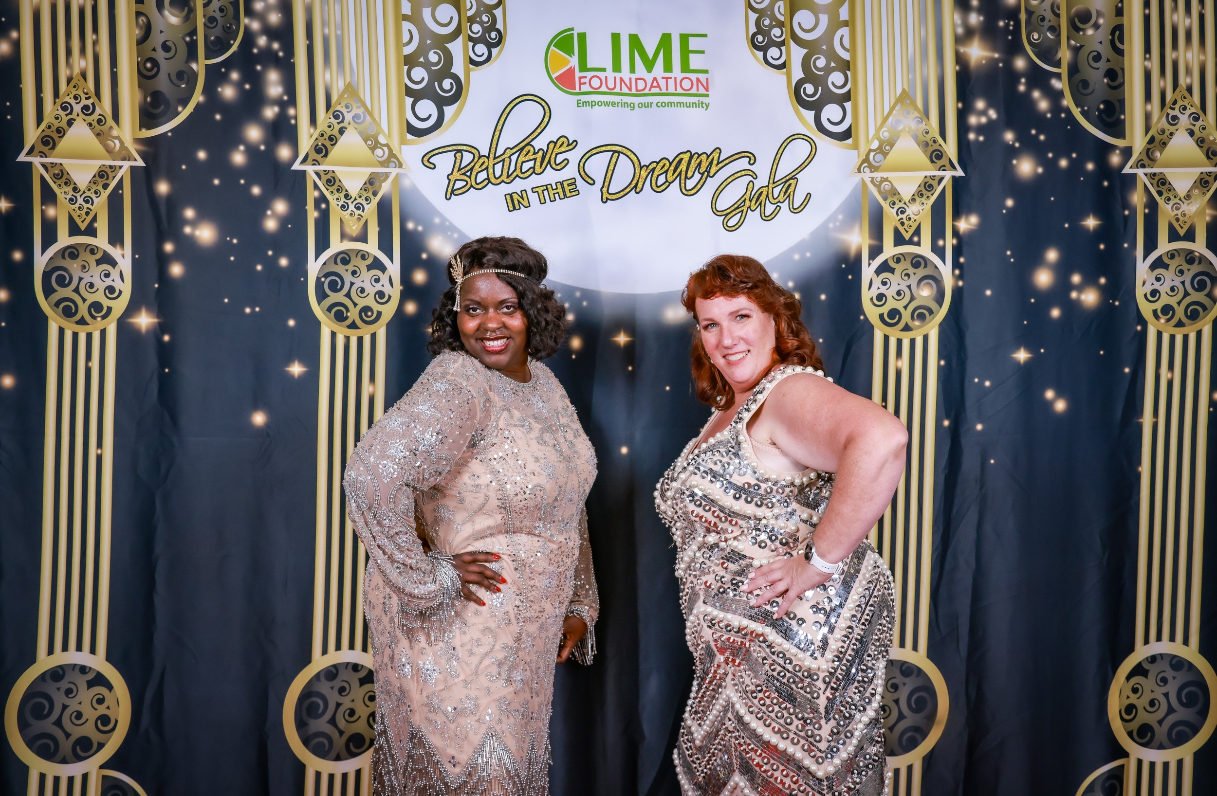 Two women posing for a photo in front of a backdrop at The LIME Foundation, a non-profit organization in Sonoma County.