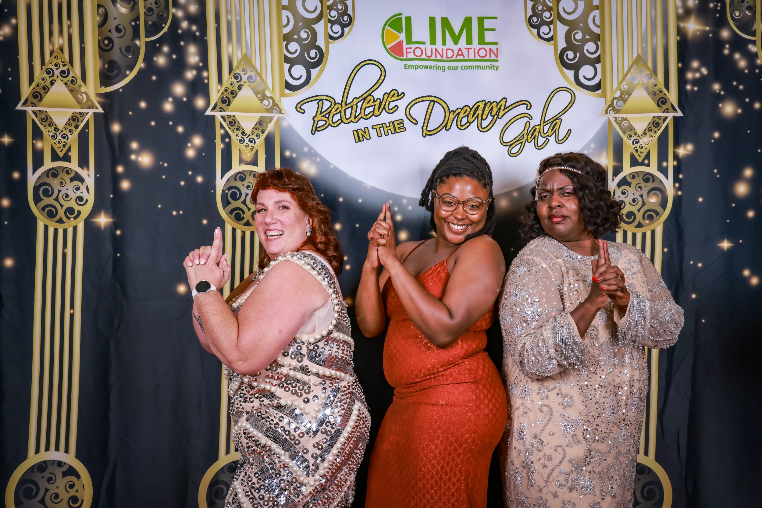 Three women posing for a photo at a 1920s themed party hosted by The LIME Foundation of Santa Rosa.