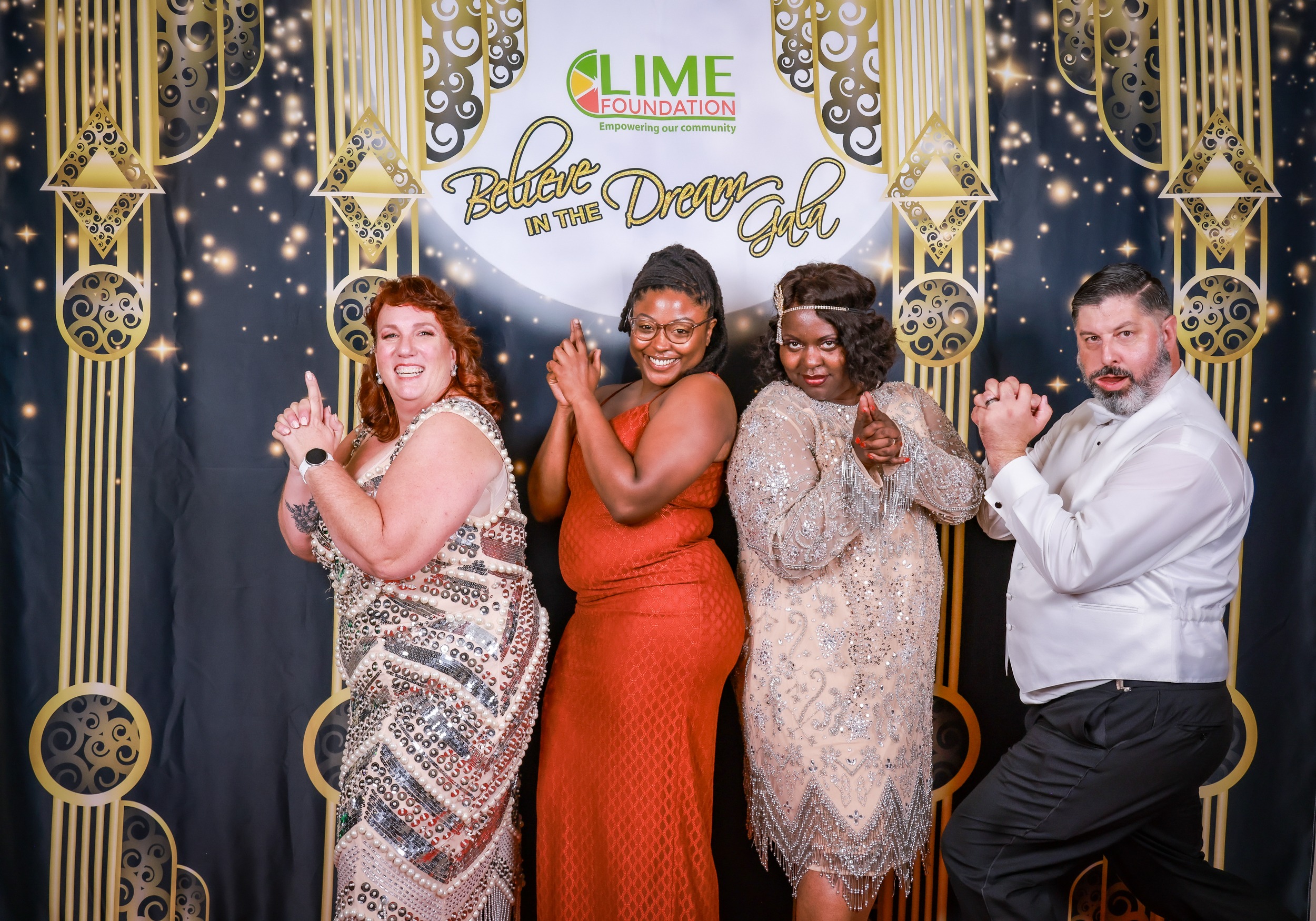A group of people posing for a photo at a party hosted by The LIME Foundation.