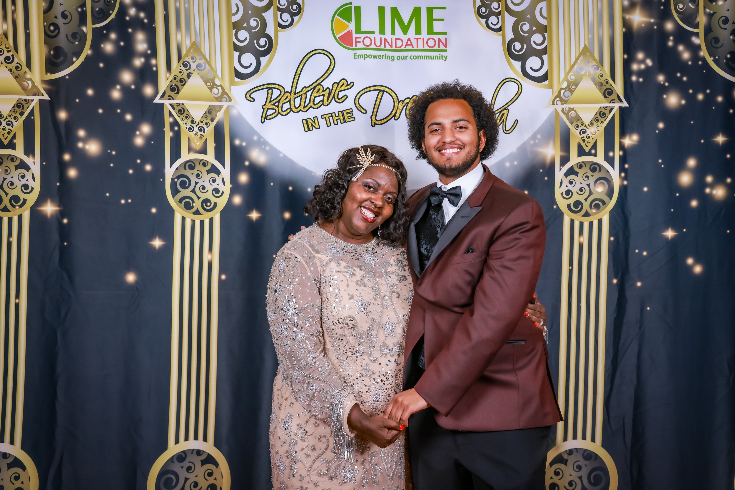 A man and woman posing for a photo at a party hosted by The LIME Foundation.