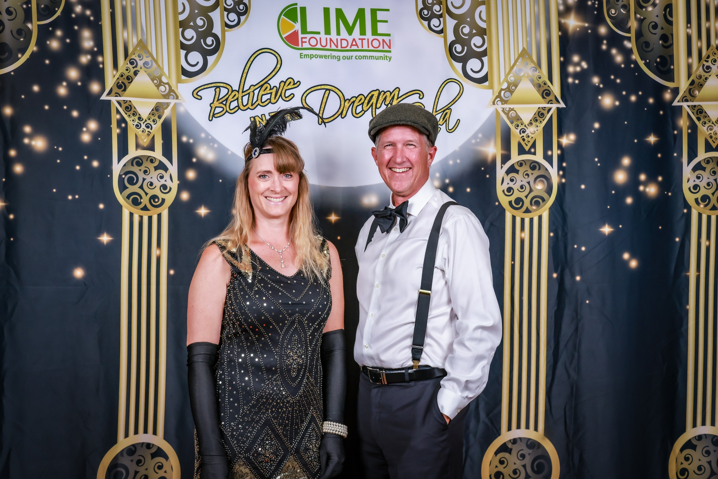 A man and woman posing for a photo at a 1920's themed party hosted by The LIME Foundation of Santa Rosa.