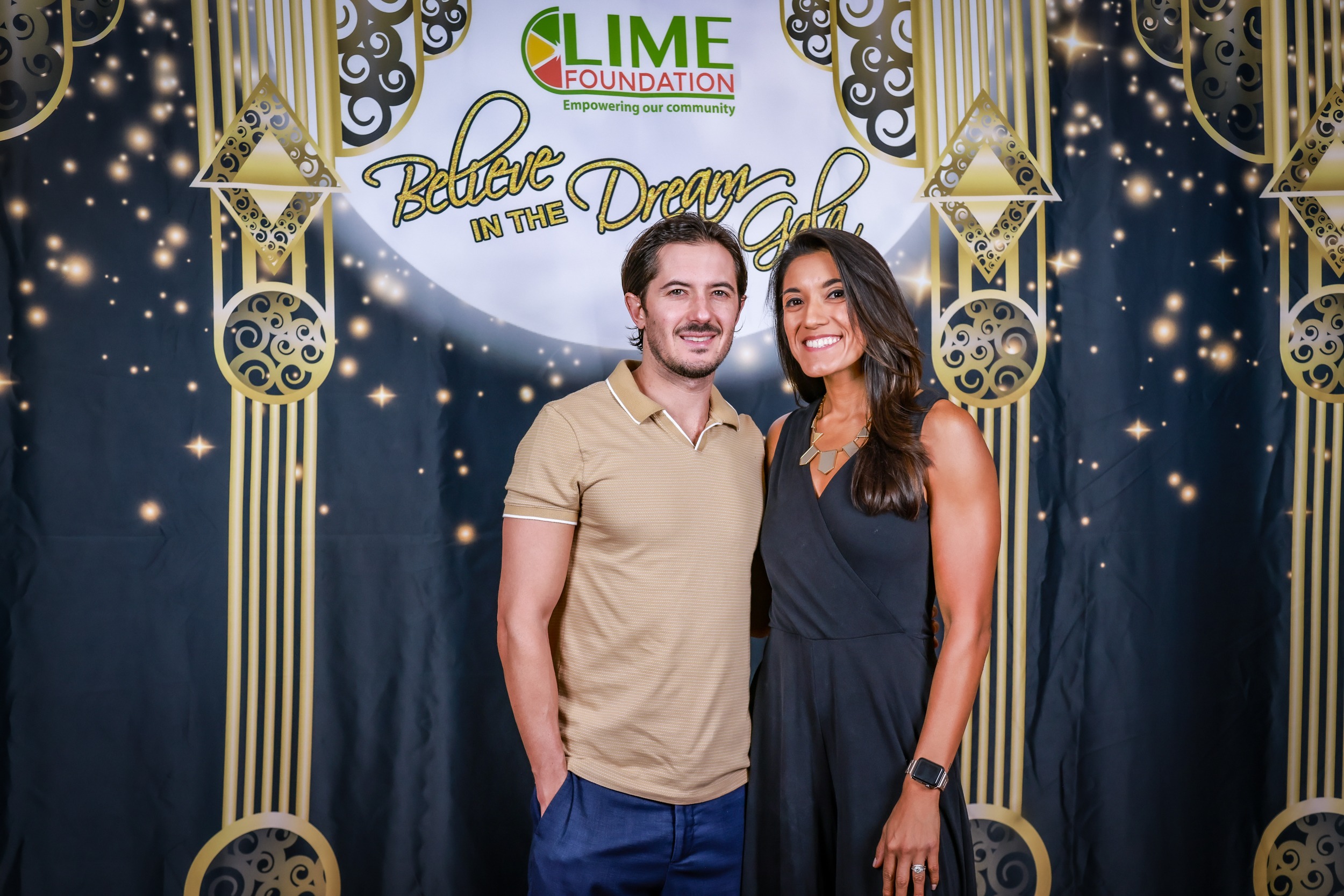 A man and woman posing for a photo in front of a backdrop at The LIME Foundation of Santa Rosa.