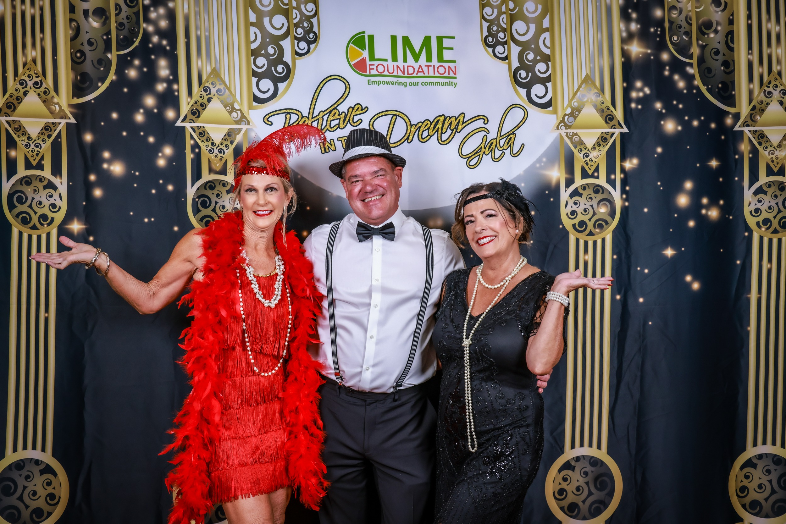 Three people posing for a photo at a Gatsby themed party hosted by The LIME Foundation of Santa Rosa.