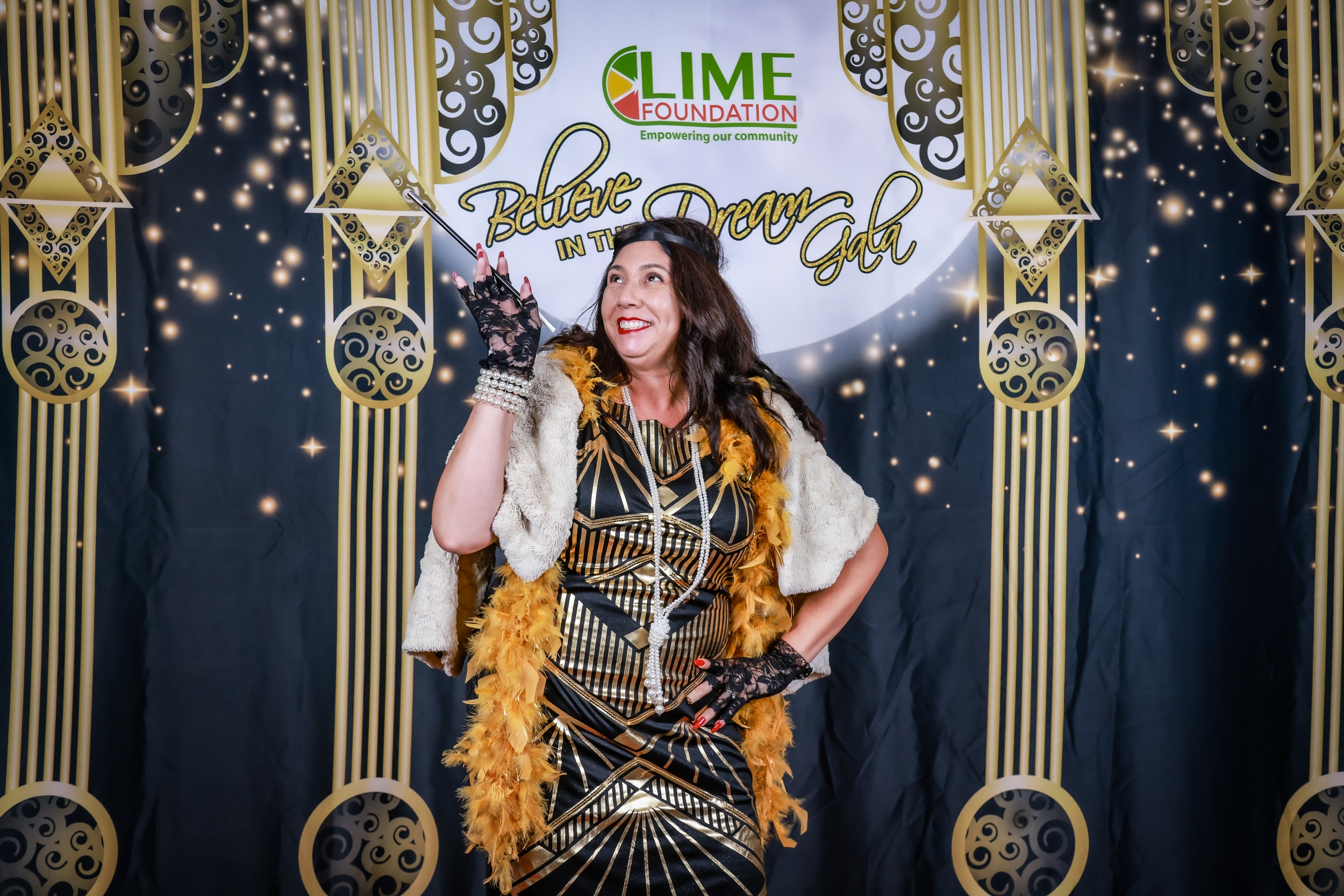 A woman in a 1920's costume is posing for a photo at The LIME Foundation of Santa Rosa.