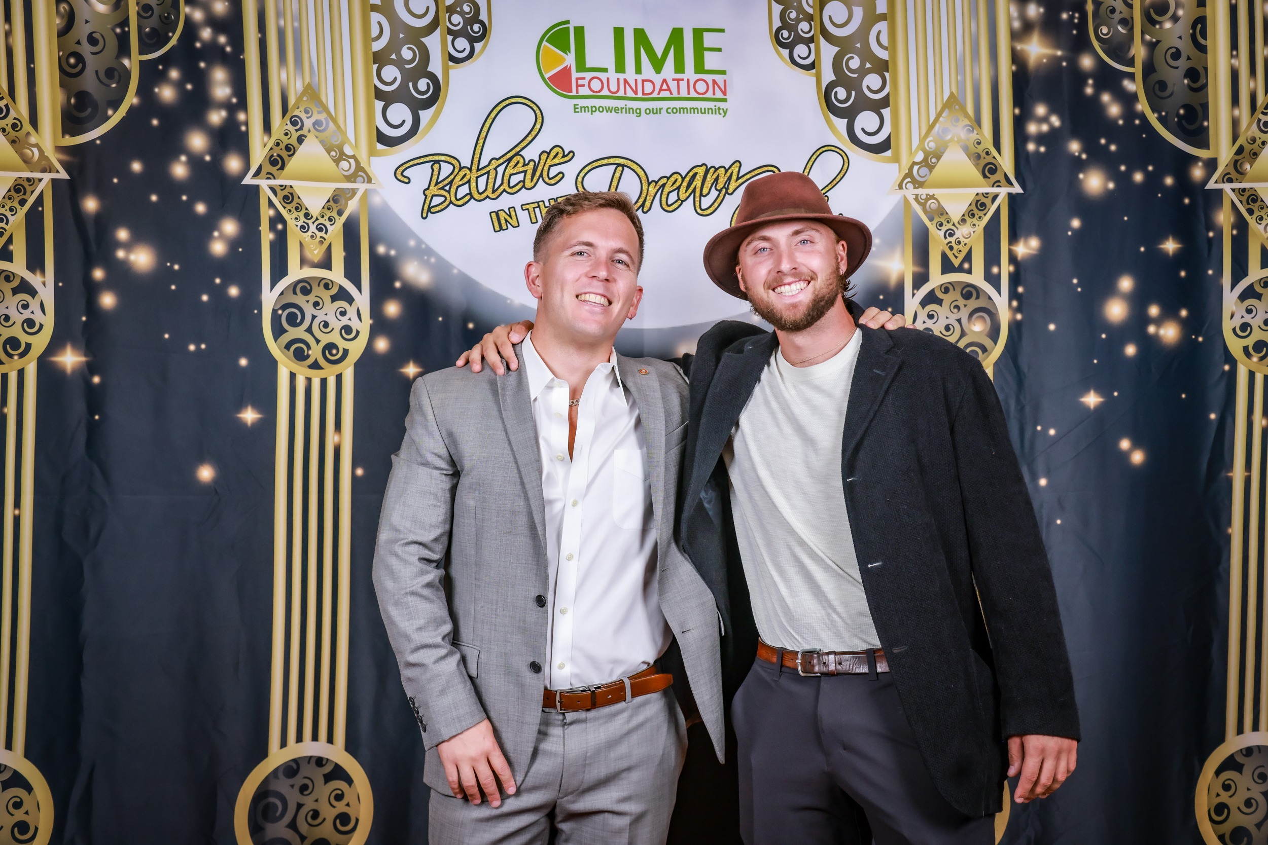 Two men posing for a photo in front of The LIME Foundation backdrop.
