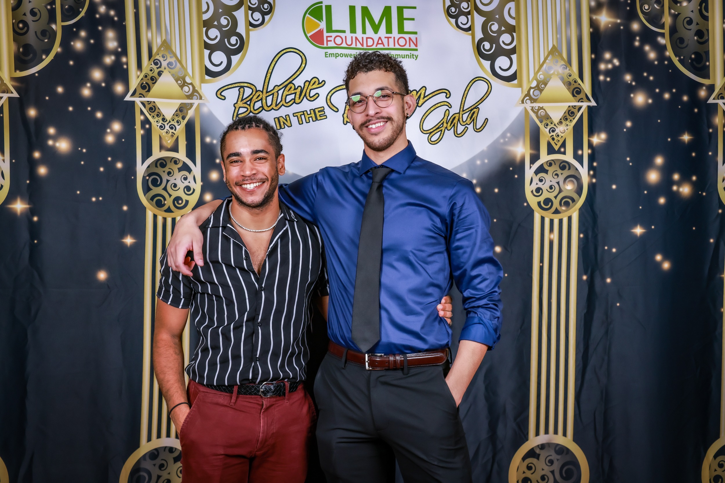 Two men posing for a photo in front of a gold backdrop at The LIME Foundation of Santa Rosa.