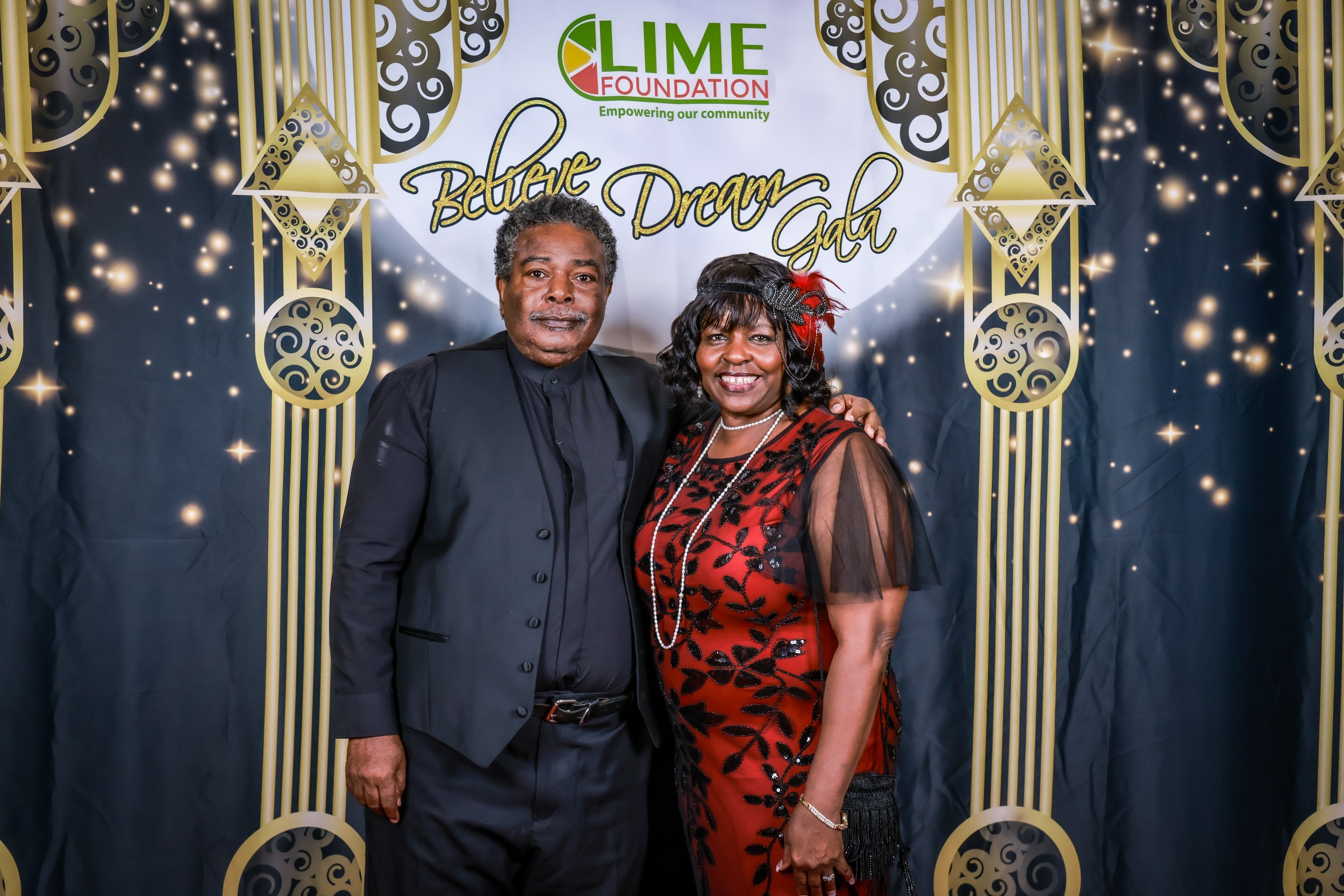 A man and woman posing for a photo on a red carpet at The LIME Foundation of Santa Rosa, a non-profit organization.