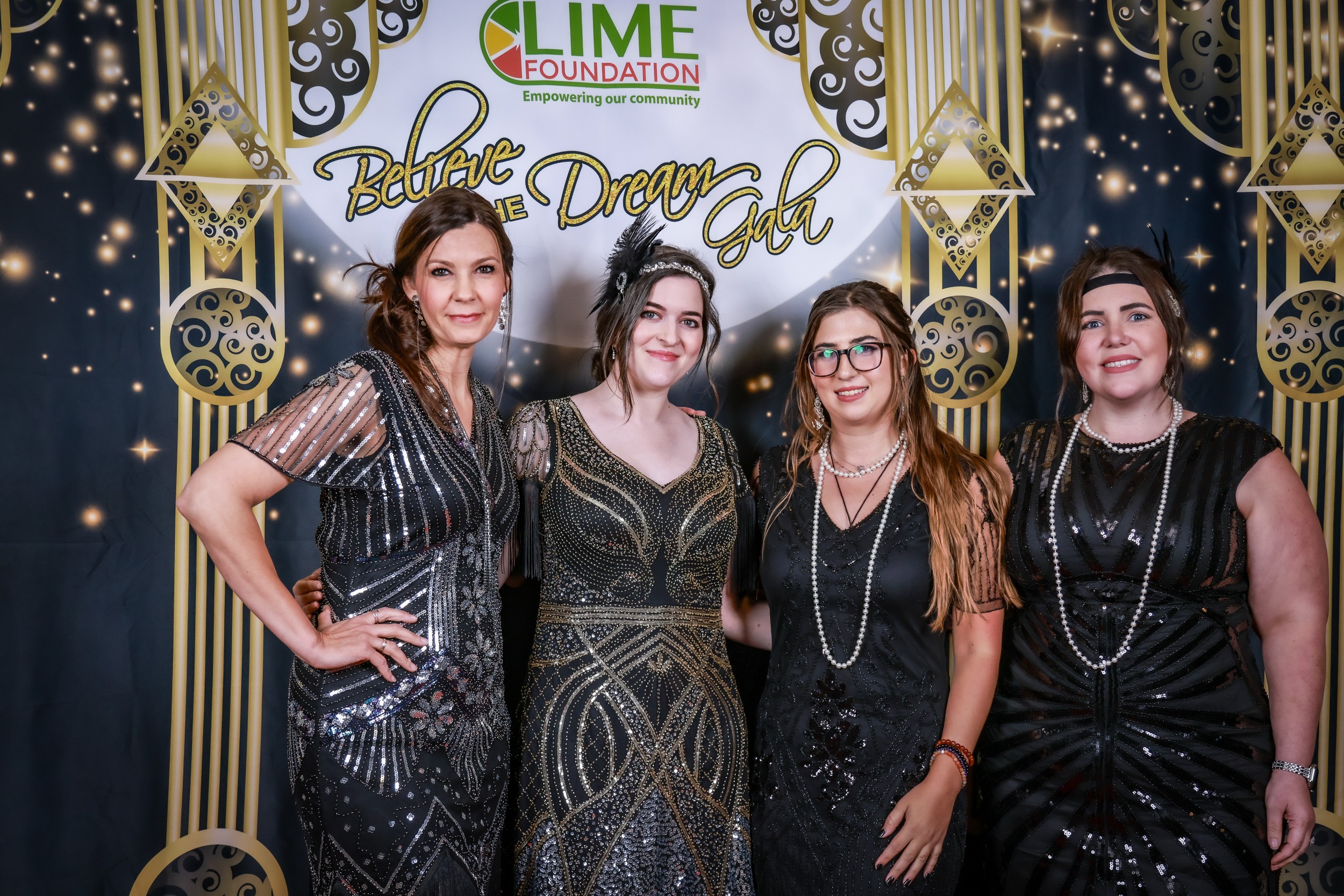 A group of women posing for a photo at a 1920's themed party hosted by The LIME Foundation of Santa Rosa.
