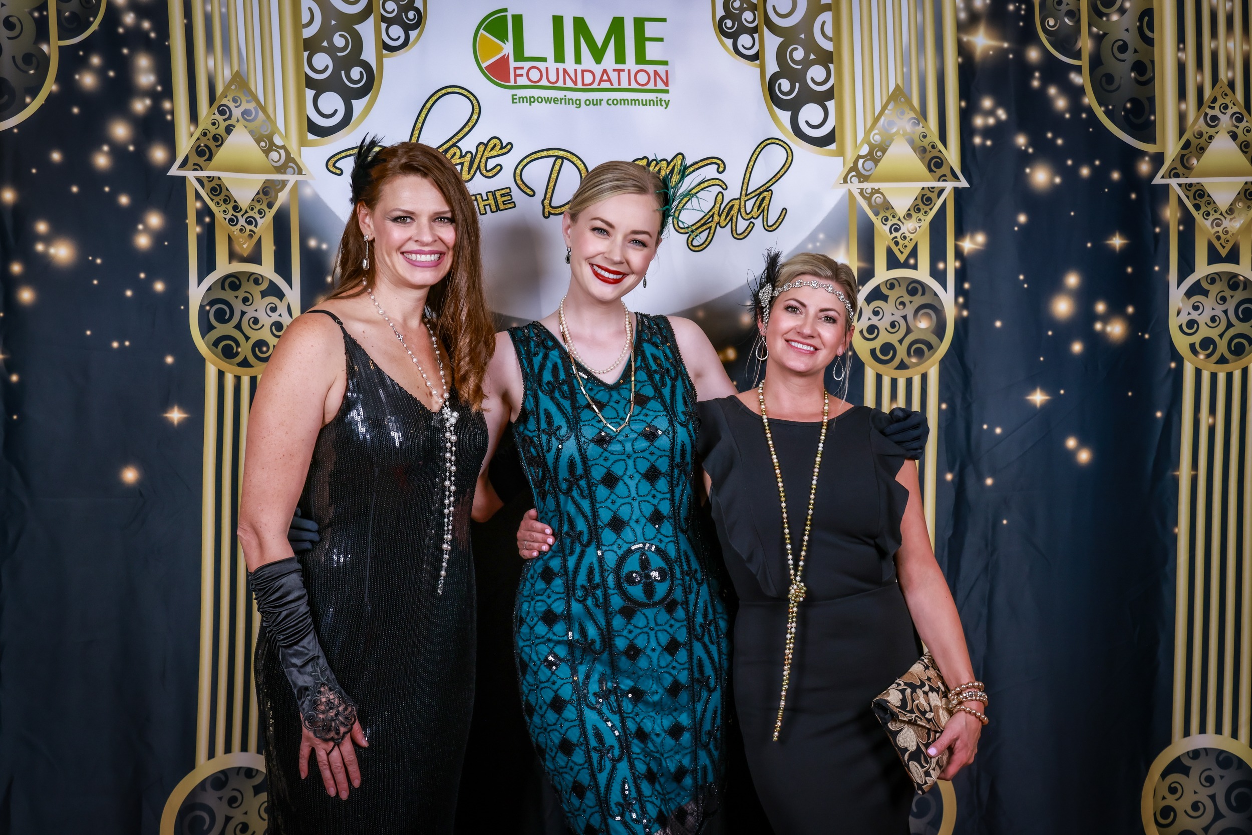 Three women posing for a photo at a Santa Rosa non-profit event hosted by The LIME Foundation.
