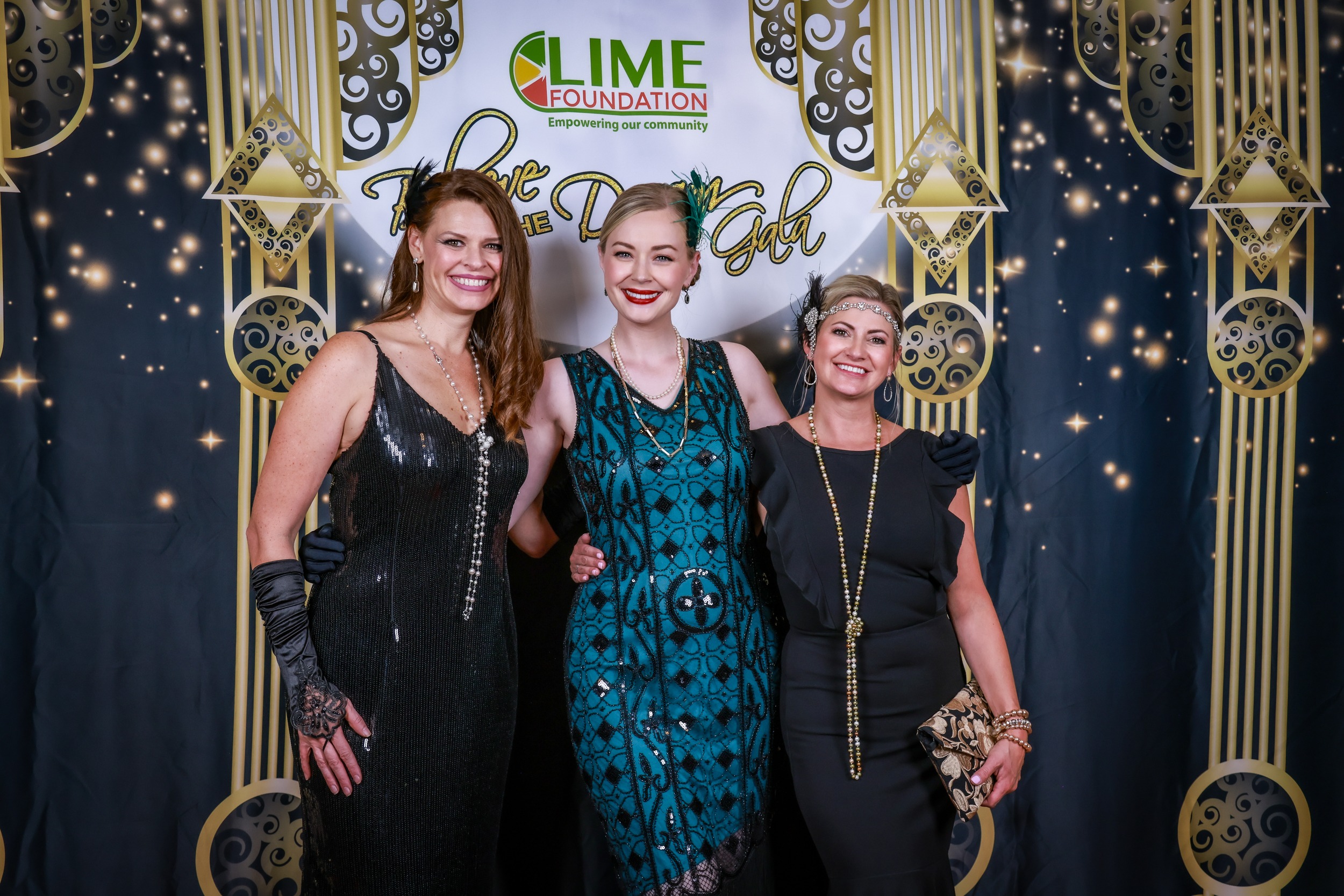 Three women posing for a photo at a LIME Foundation event.